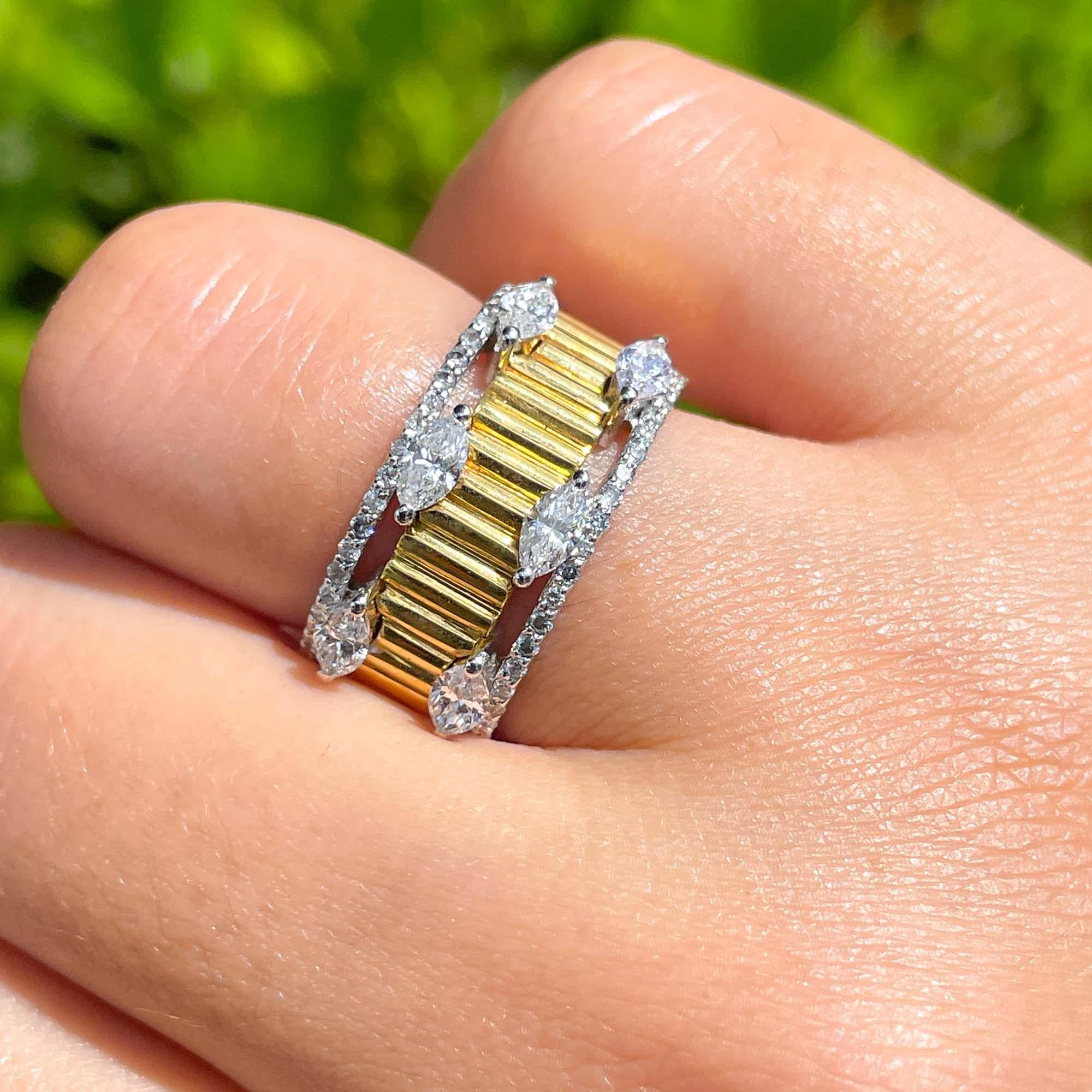 Jay Feder 18k Two Tone Gold Diamond Band Ring

Set with marquise and round brilliant diamonds; total carat weight is 1.10ct. 

The band is 10.12mm wide. Sits 3.19mm from the top of the finger. Ring size is 7.5 (please contact for sizing PRIOR