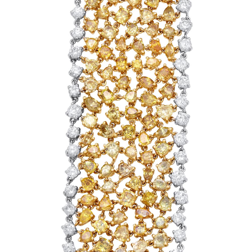 Jay Feder 18k Two Tone Gold Fancy Yellow Diamond and White Diamond Bracelet 
Set with White and Fancy Yellow Mixed shaped diamonds; estimated total weight is 43.15ctw.
The bracelet is 7 inches long; links are 1.25 inches wide.
The total weight of