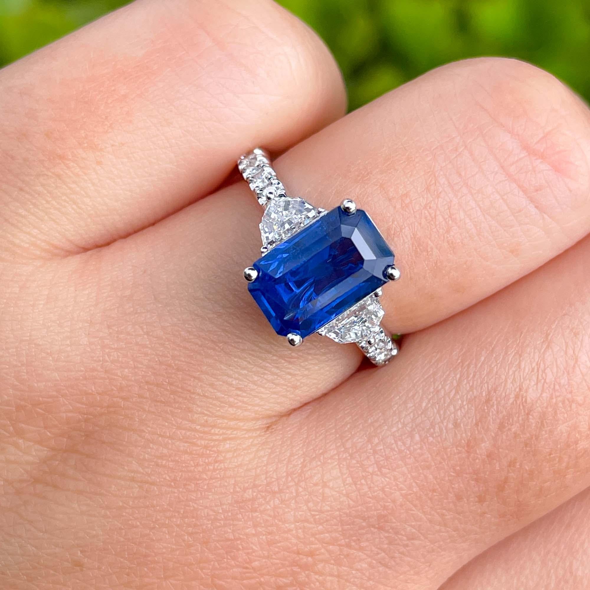 Jay Feder 18k White Gold Blue Sapphire and Diamond Three Stone Ring

The center stone is 2.87ct Natural Blue Sapphire Emerald; set with 2 cadillac diamonds(0.47ct) and accented with 0.23ct small round diamonds on the band.

The band width tapers