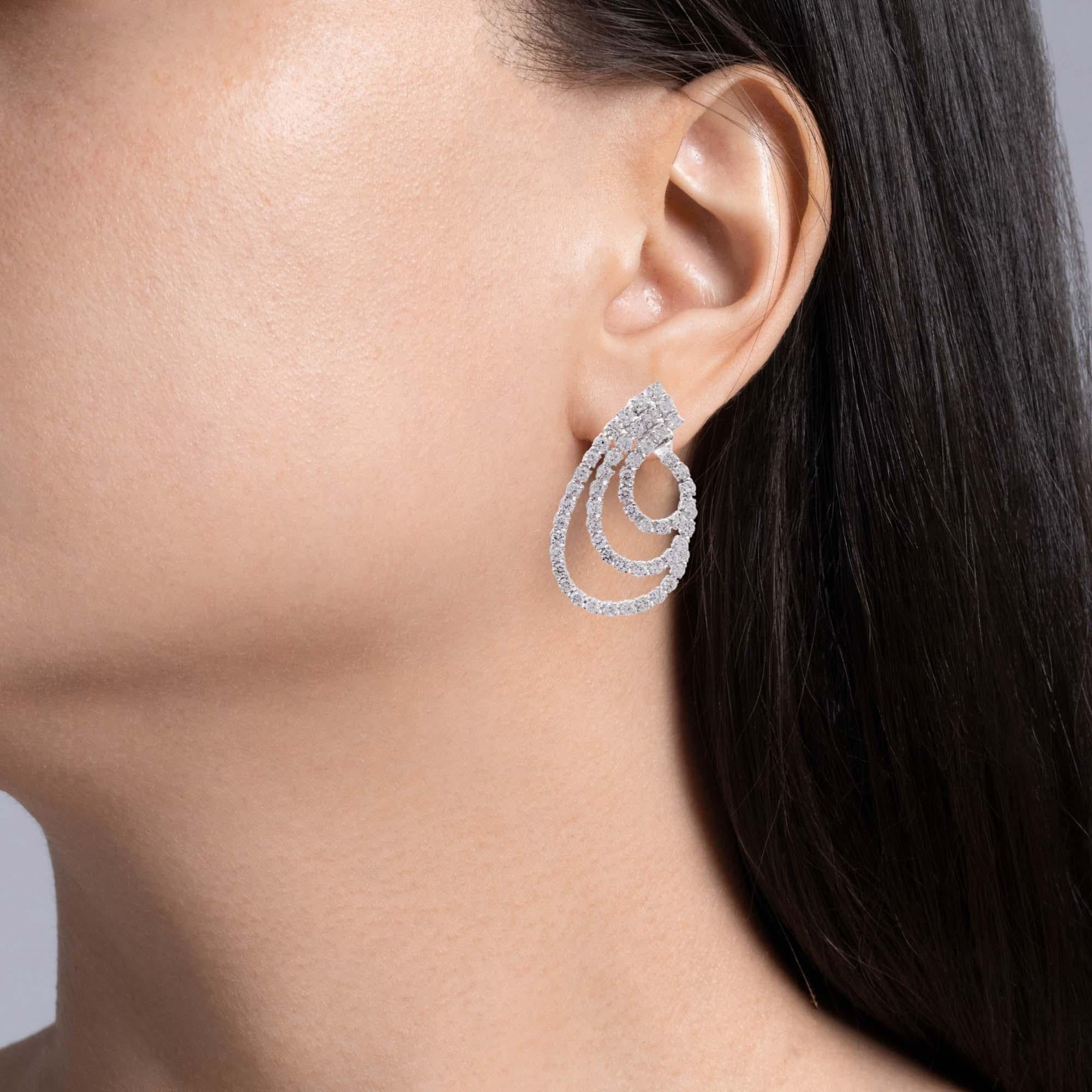 Jay Feder 18k White Gold Diamond 3 Row Swirl Drop Earrings

Set with round diamonds; total carat weight is 9.9ct.

The earrings are 2 inches long and 1 1/8 inches wide. Total weight is 18.8 grams. 

Please view our photos and videos for more