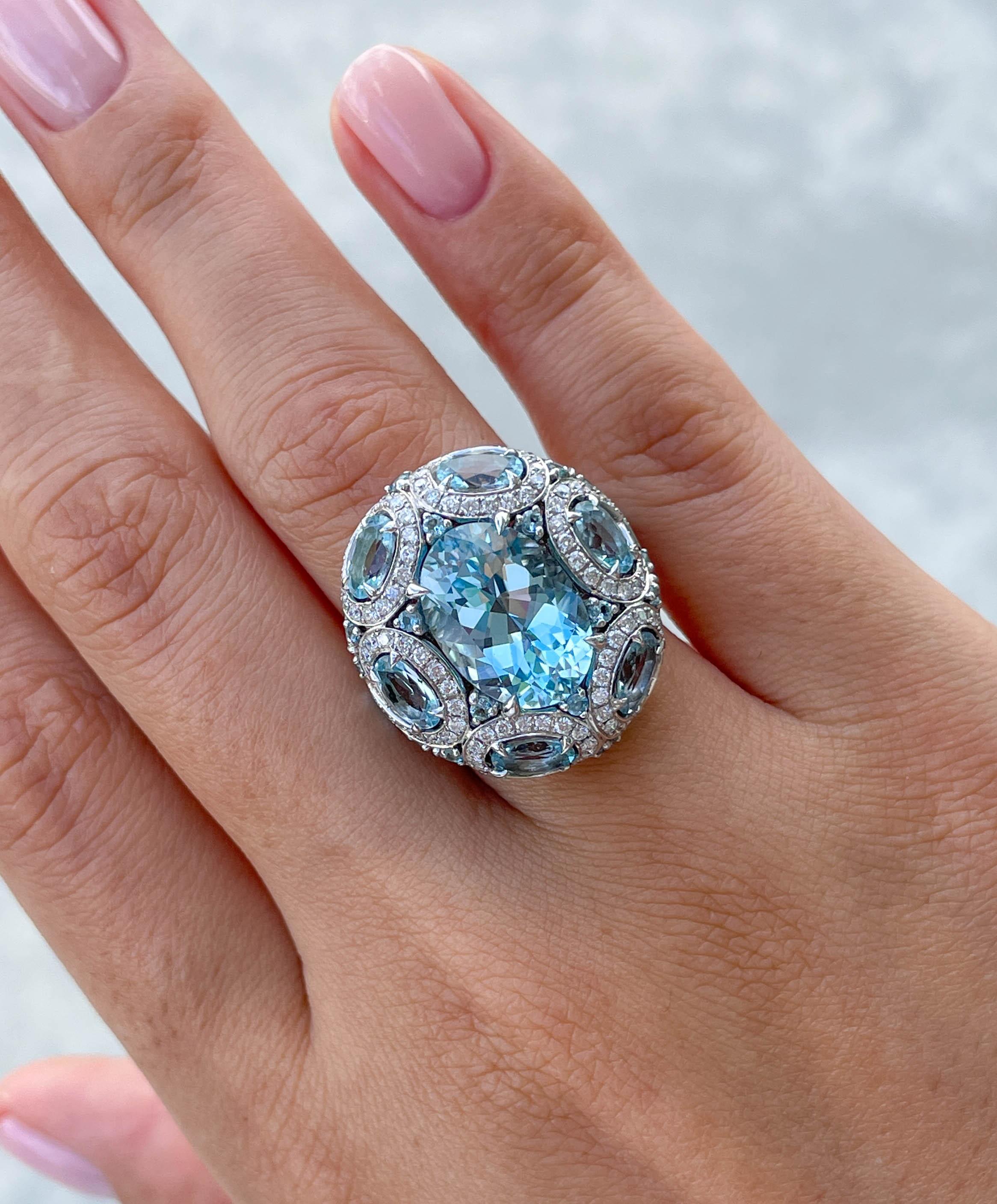 Jay Feder Blue Topaz and Diamond ring in 18k White gold with Oval shaped Blue Topaz in the center set with smaller oval shaped topaz around; estimated total weight is 1.44ctw.
Set with 36 Oval and round shaped Blue Topaz; estimated total weight is
