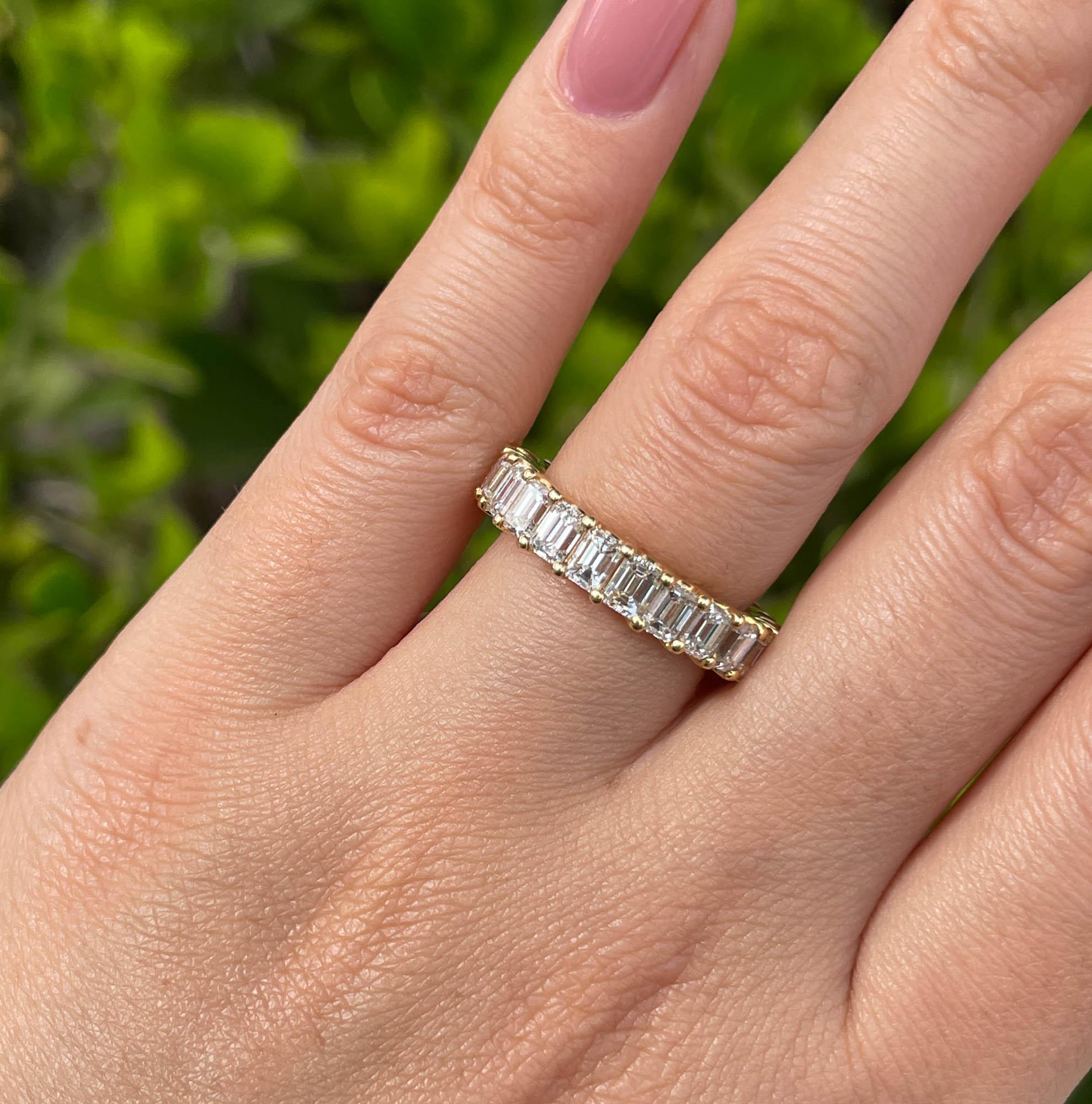 Jay Feder 18k Yellow Gold Emerald cut Diamond Eternity Wedding Band

There are 23 Emerald cut diamonds; total carat weight is 5.48 carats; VS clarity overall.

Sits 3.40mm from the top off the finger. The band is 3.90mm wide. Total weight of the