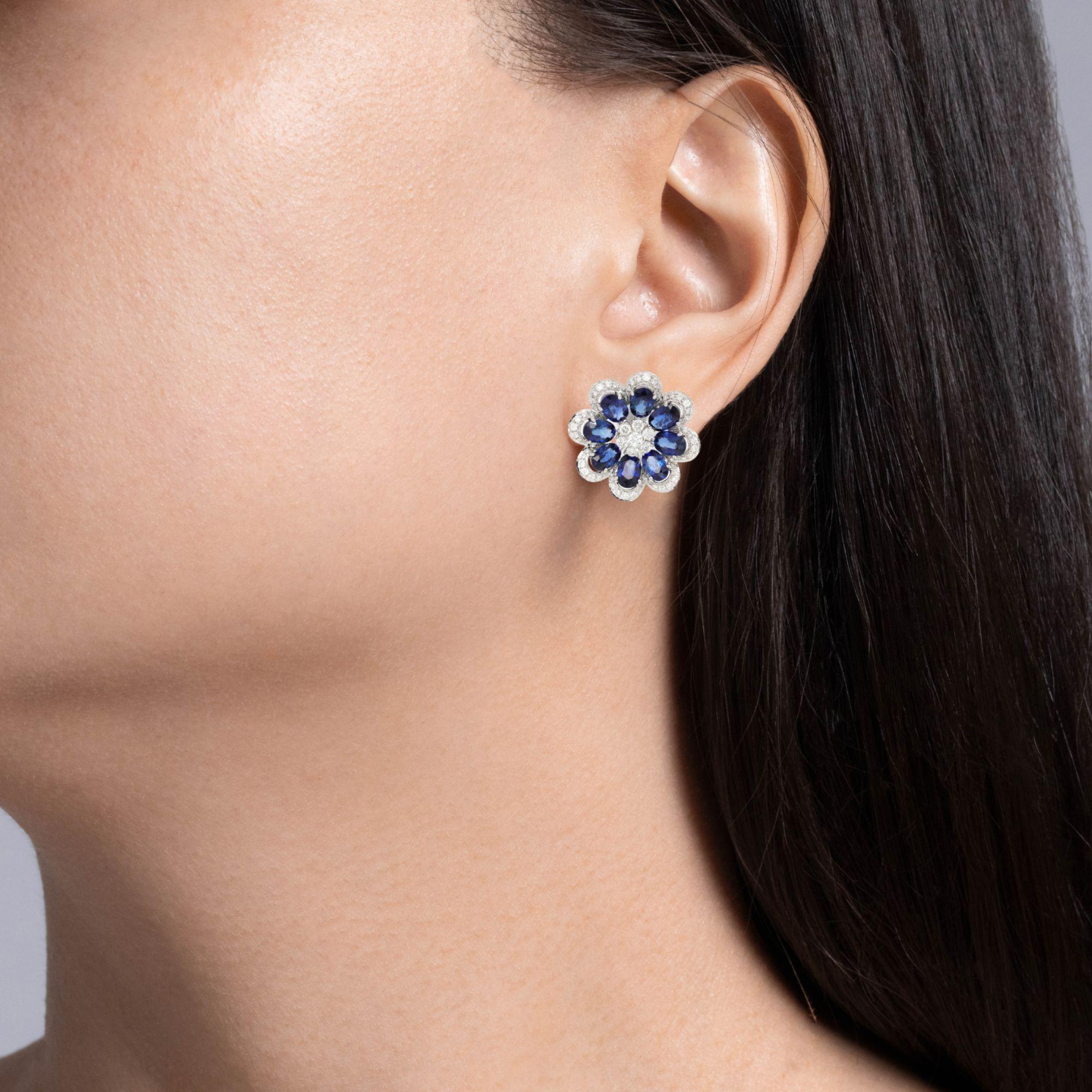 Jay Feder Blue Sapphire and Diamond Flower earrings in 18k White gold with 8.58ctw Oval shaped Blue Sapphires and 1.56ctw round brilliant diamonds. 

Each earring is almost 23mm long and 23mm wide. The total weight is 12.6 grams.  

(All carat