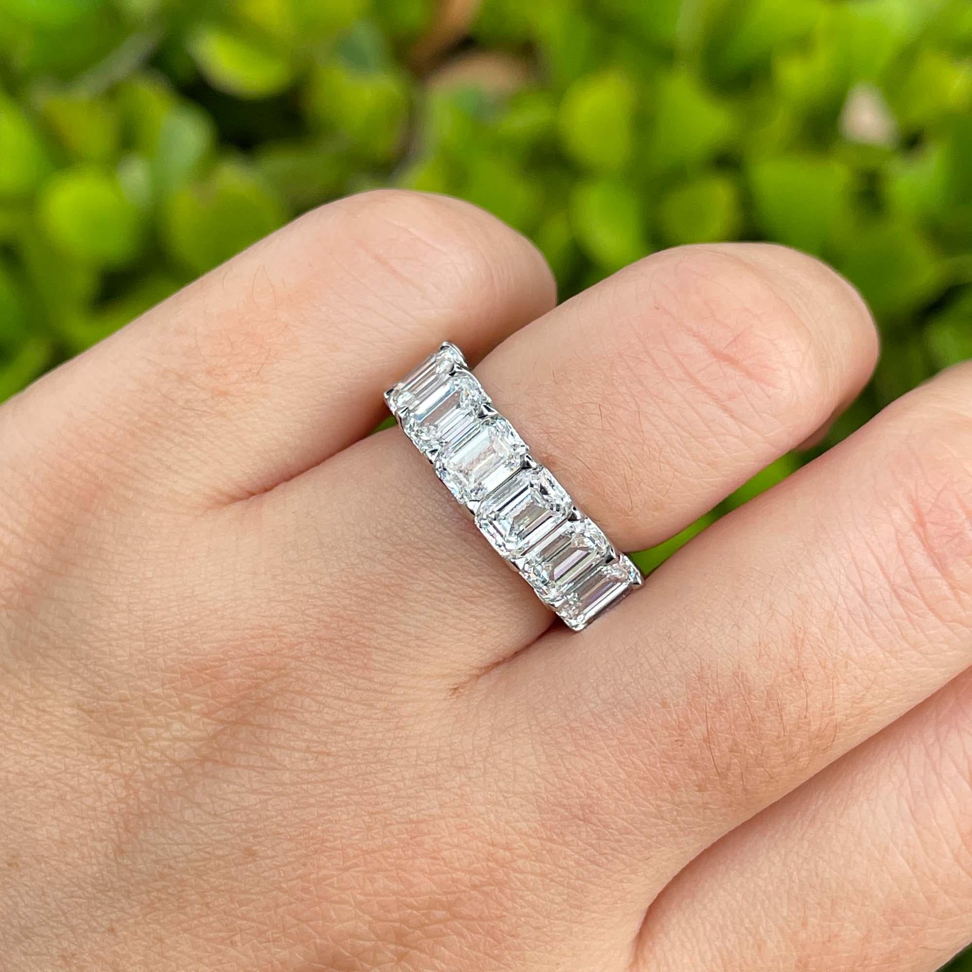 Jay Feder Platinum Emerald Diamond Eternity Band Ring

Set with 15 emerald cut diamonds; total carat weight is 10.58ct. 

The band's width is 6.28mm, sits 3.24mm from the top of the finger. Ring size is 6 (non-resizable). Total weight is 7.1 grams.