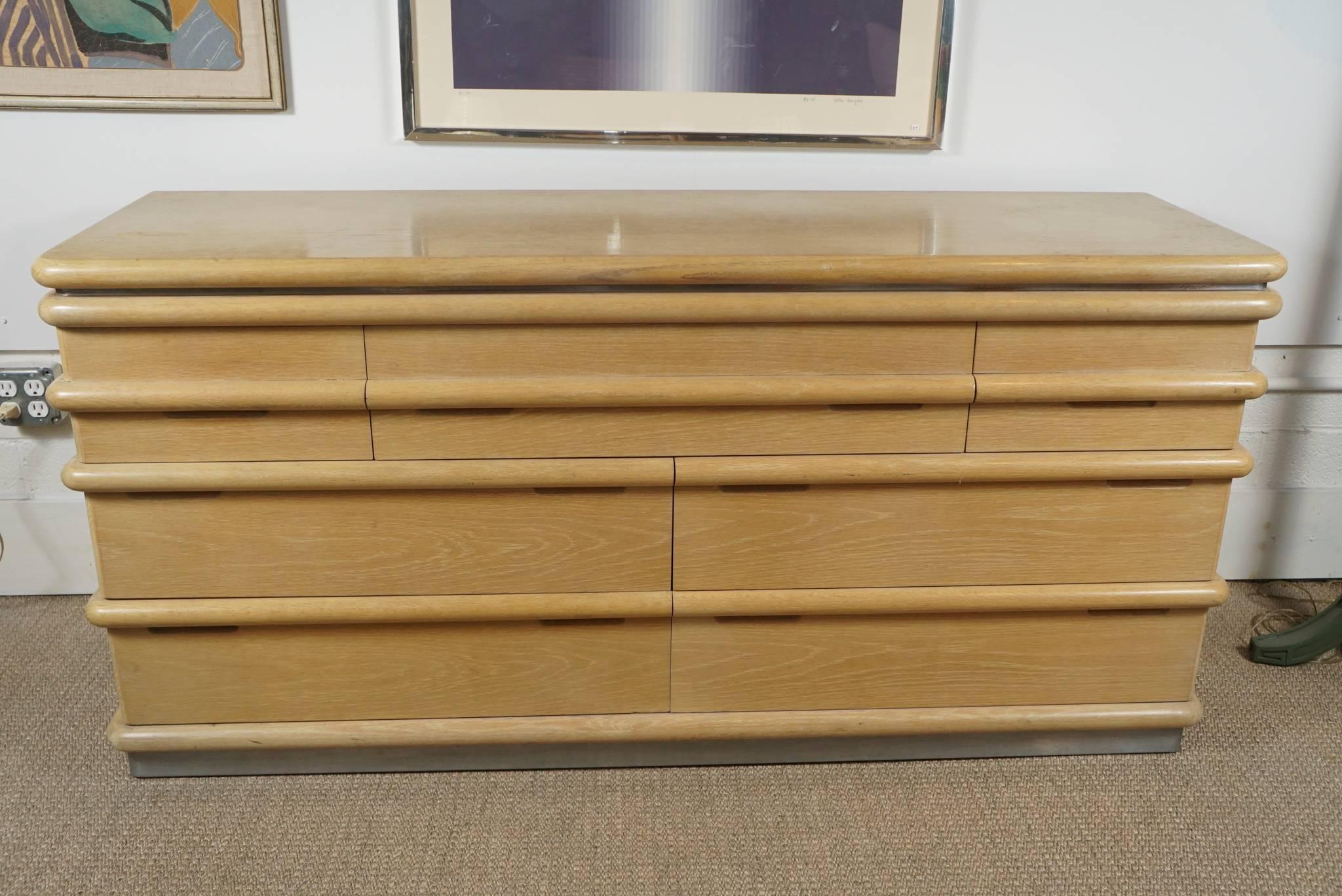 Here is a great dresser in a blonde oak by Jay Spectre for Century.
The piece features various drawer sizes and has a brushed aluminium base.