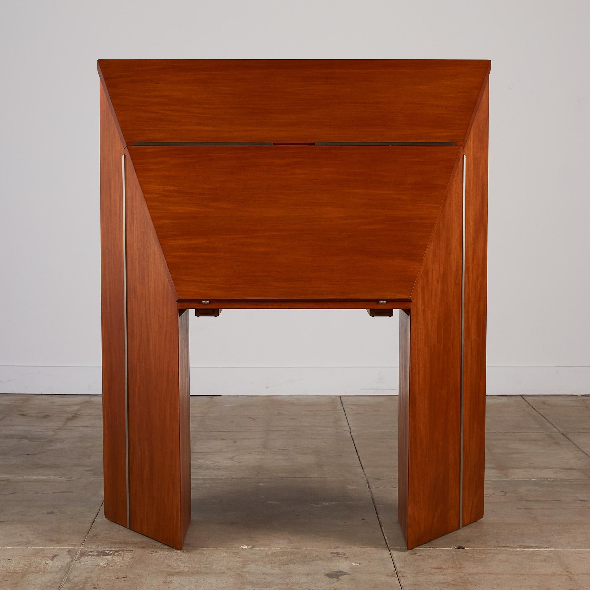 This unique desk by Jay Spectre's Perimeter Collection for Century c.1980s, USA will be a standout piece of any room. This drop front mahogany desk features a brushed stainless steel detail that carries all the way around each side and the top of