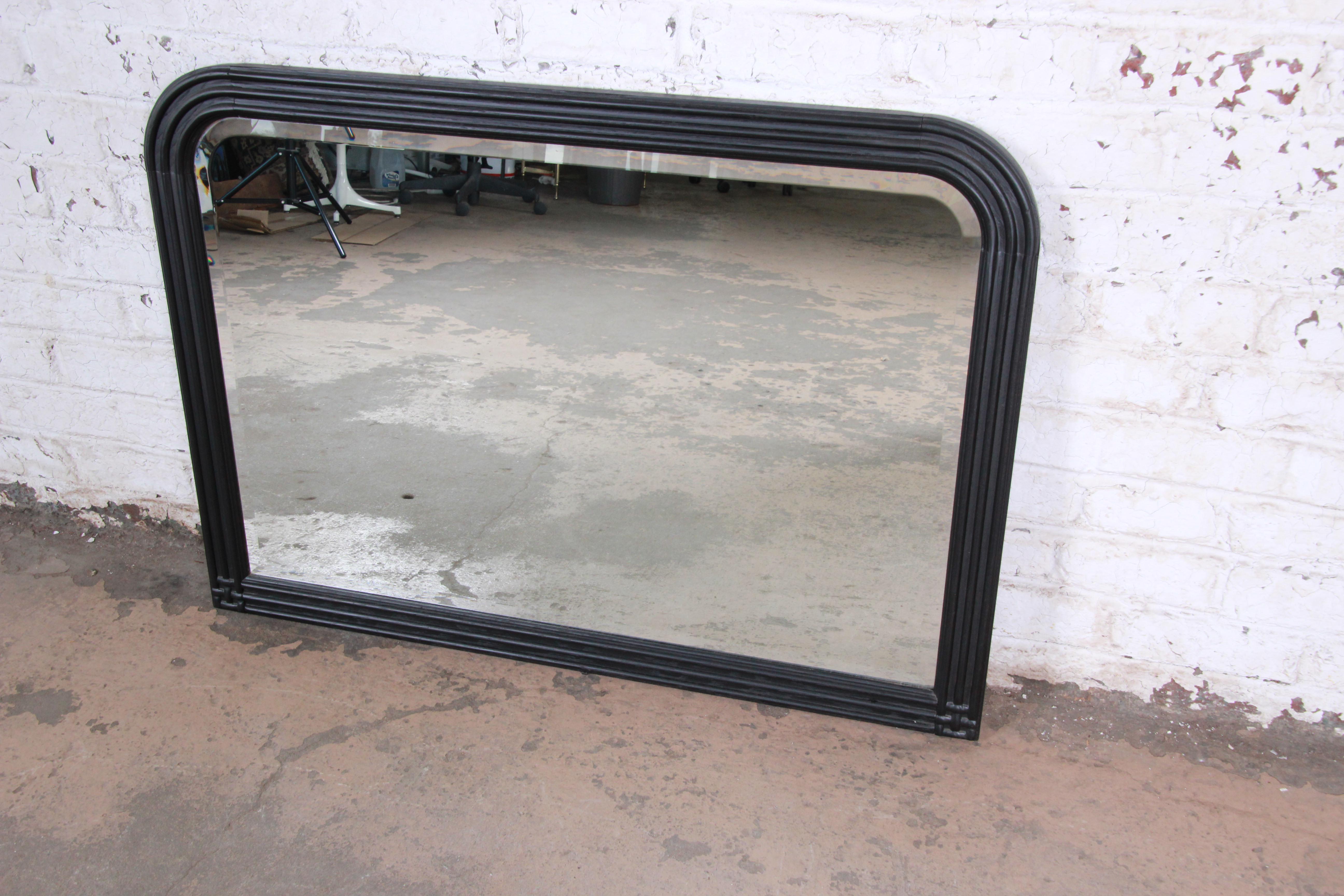 A nice black lacquered oak mirror by Jay Spectre for Century Furniture. The mirror has a nice rounded beveled edge at the top corners. The mirror has newly been refinished and is in excellent condition.