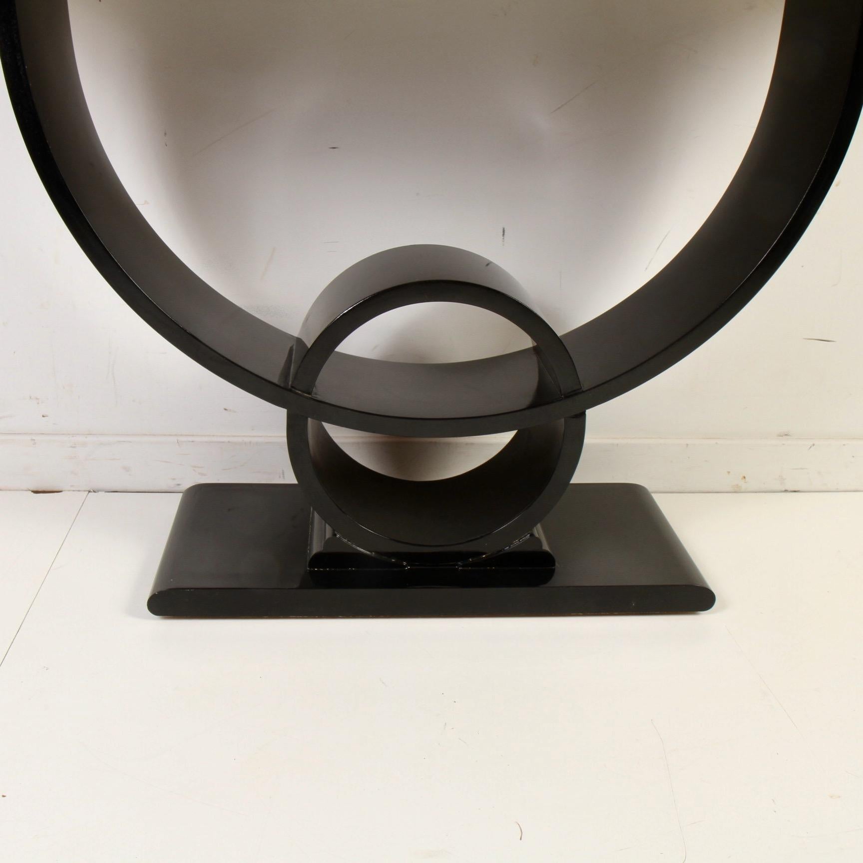 French Art Deco console table by Jay Spectre, featuring a gold leaf top and high-gloss ebony lacquered base. Solid hardwood construction with a Classic Art Deco lines. Gold leaf is in decent shape and shows well. The wall facing edge has a few nicks