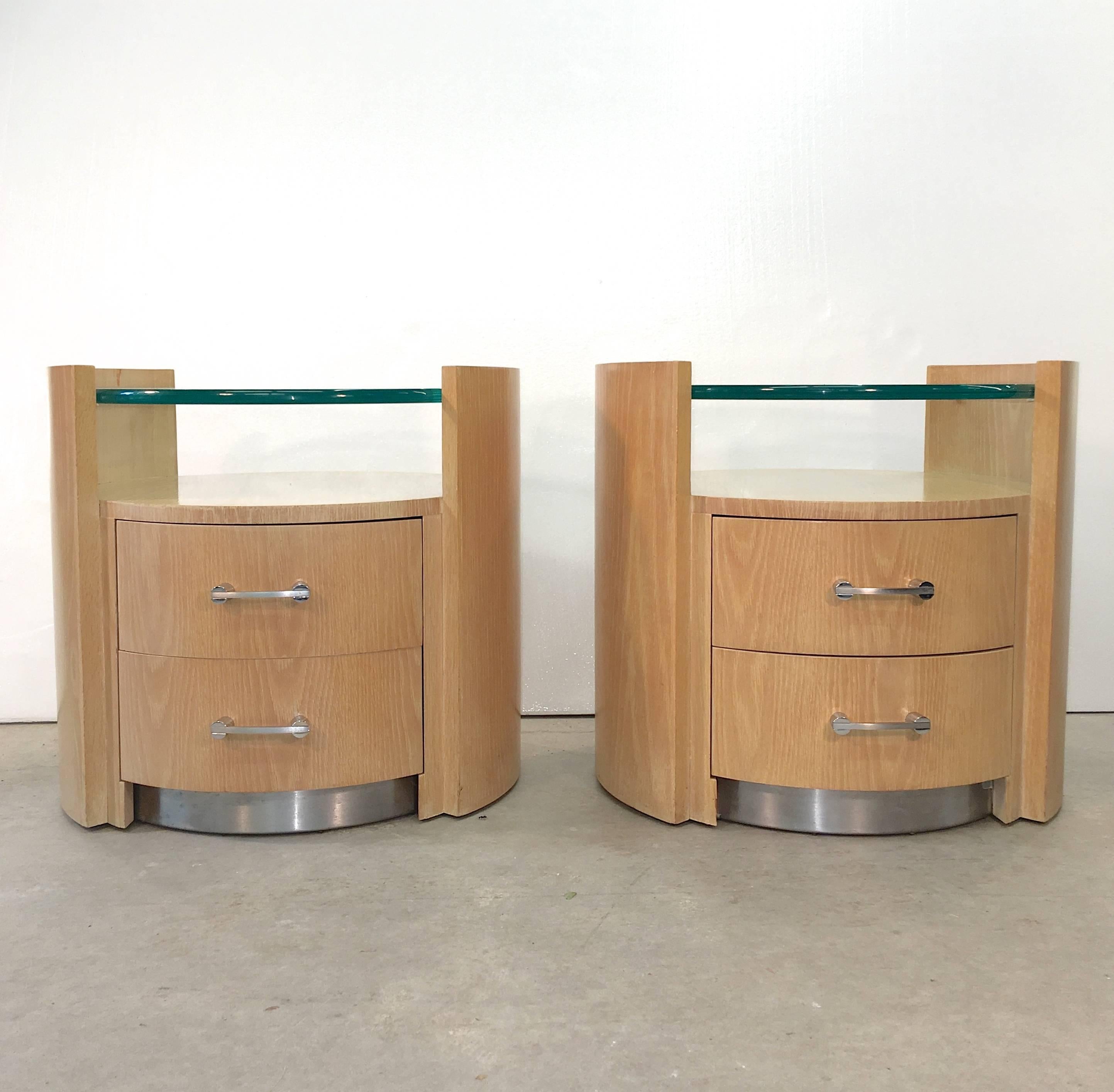 Pair of cerused oak nightstands in ovoid form with two drawers, brush stainless pulls and recessed plinth with floating glass top by Jay Spectre for Century Furniture.