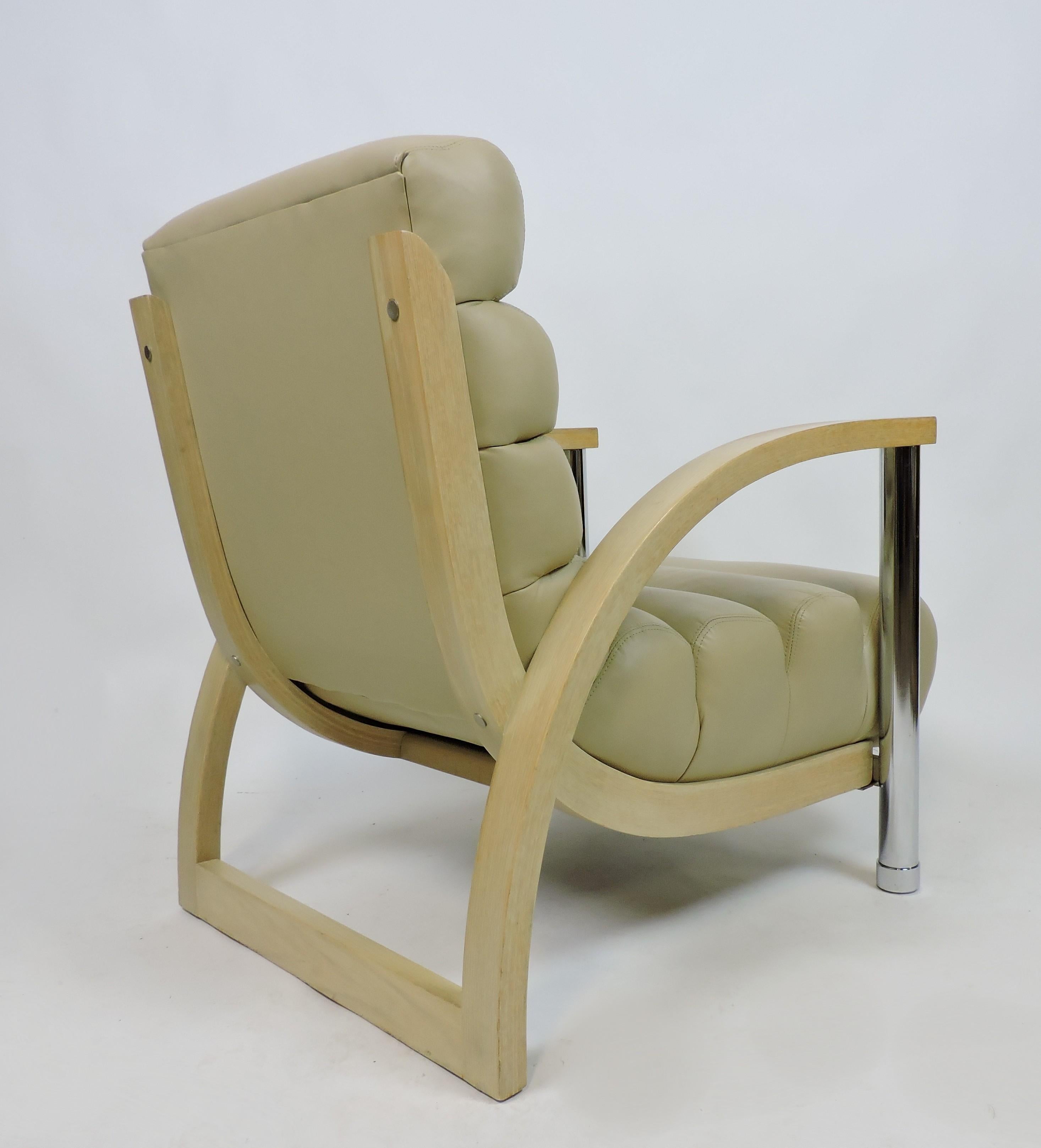 Striking looking and comfortable Eclipse lounge chair designed by Jay Spectre and manufactured by Century Furniture Company. This chair has a channeled leather cushion supported by arcs of light oak that rest on chrome tubular front legs.