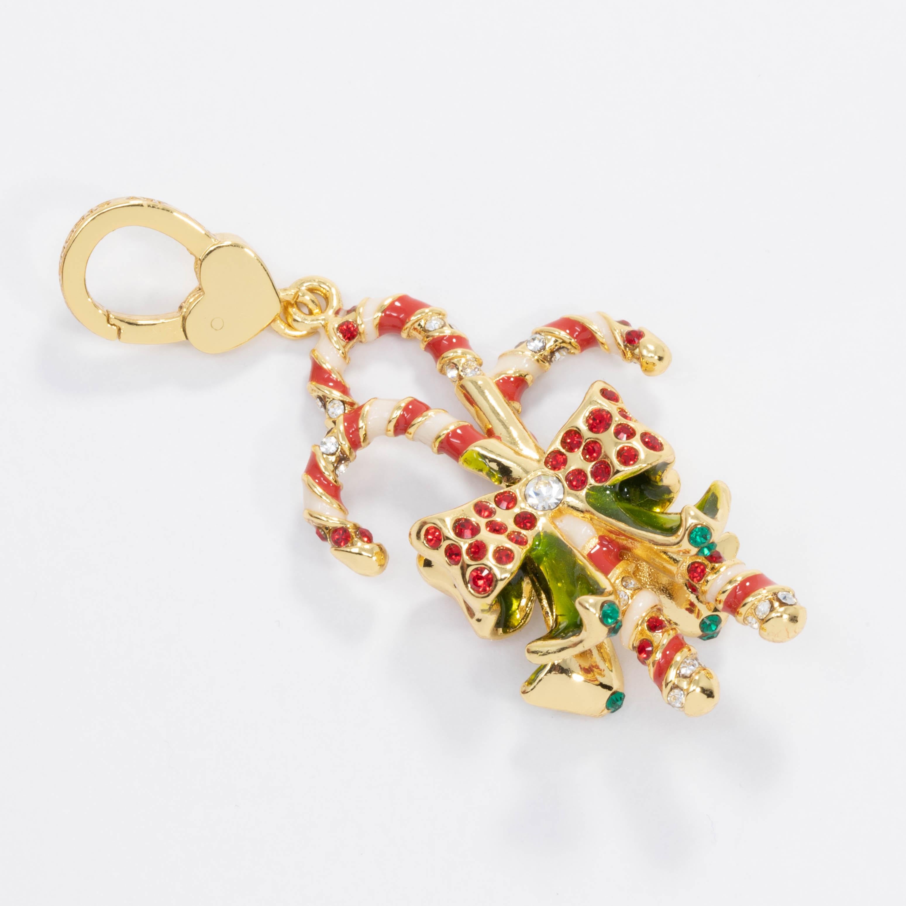 A festive candy cane cluster charm, featuring three red and white enamel painted candy canes wrapped with a crystal-accented bow motif. Can be worn as a necklace pendant or a charm accessory. Gold plated.

From exclusive JAY line by Jay Strongwater