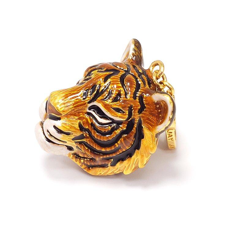 Hand-painted tiger head charm by Jay Strongwater. Shades of yellow, orange, and brown enamel, accented with black and white detailing. This charm can be worn on a bracelet, as a necklace pendant, or even on a keychain. Excellent