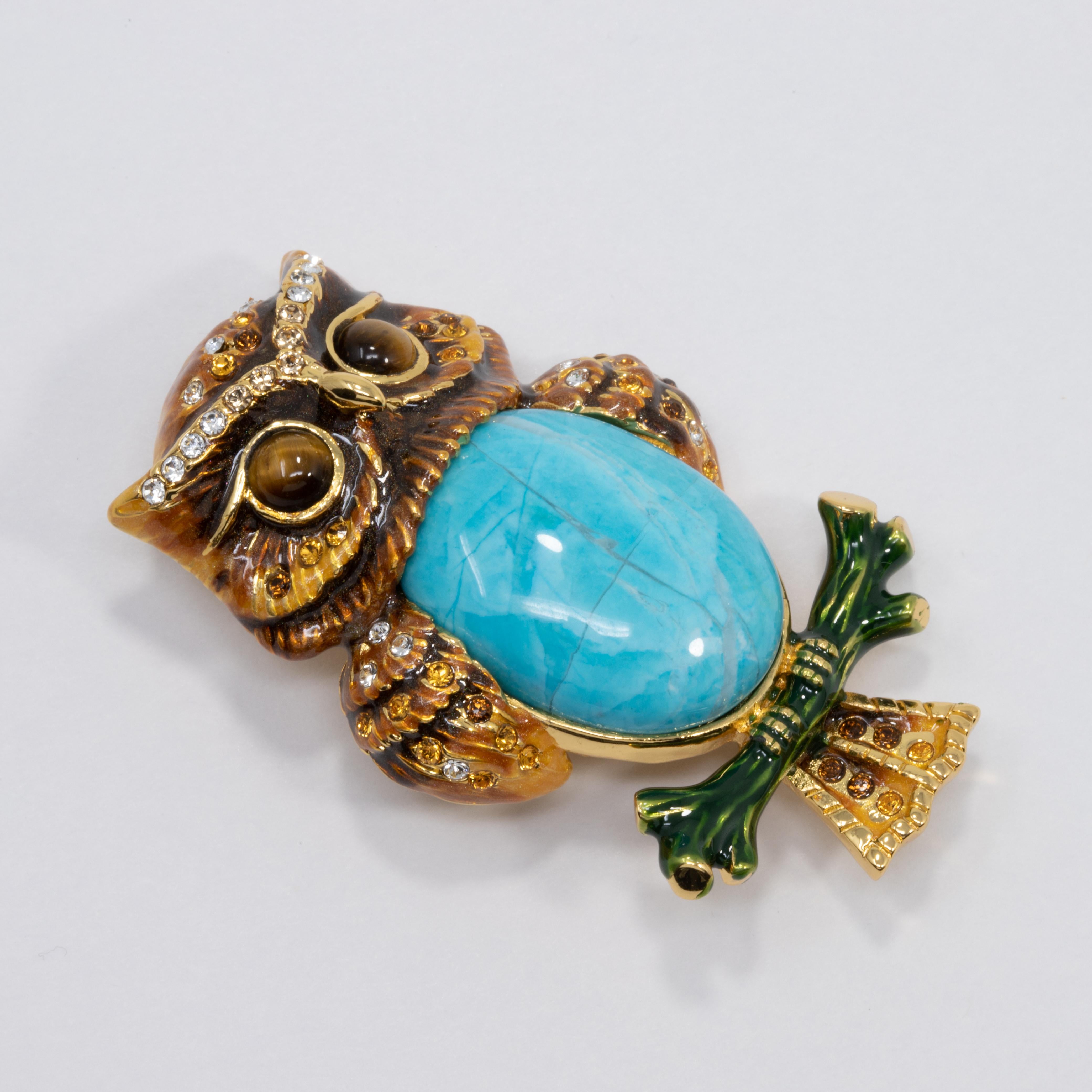 A dazzling, stylish, pin from Jay Strongwater. Features a centerpiece turquoise cabochon, as well as amber and clear crystals accents on this pretty, enamel-painted golden owl.

Gold plated.

From Jay Strongwater's JAY line for HSN.

Hallmarks: Jay,