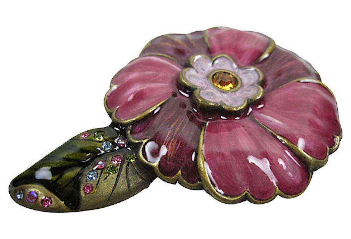 A vintage Jay Strongwater floral form purse mirror, hand enameled with Swarovski crystal accents. With the original signature snap keeper pouch. 

A Saks Fifth Avenue exclusive, out of production. 

Measures: Mirror is 3 in. L x 1.75 in. W x .25