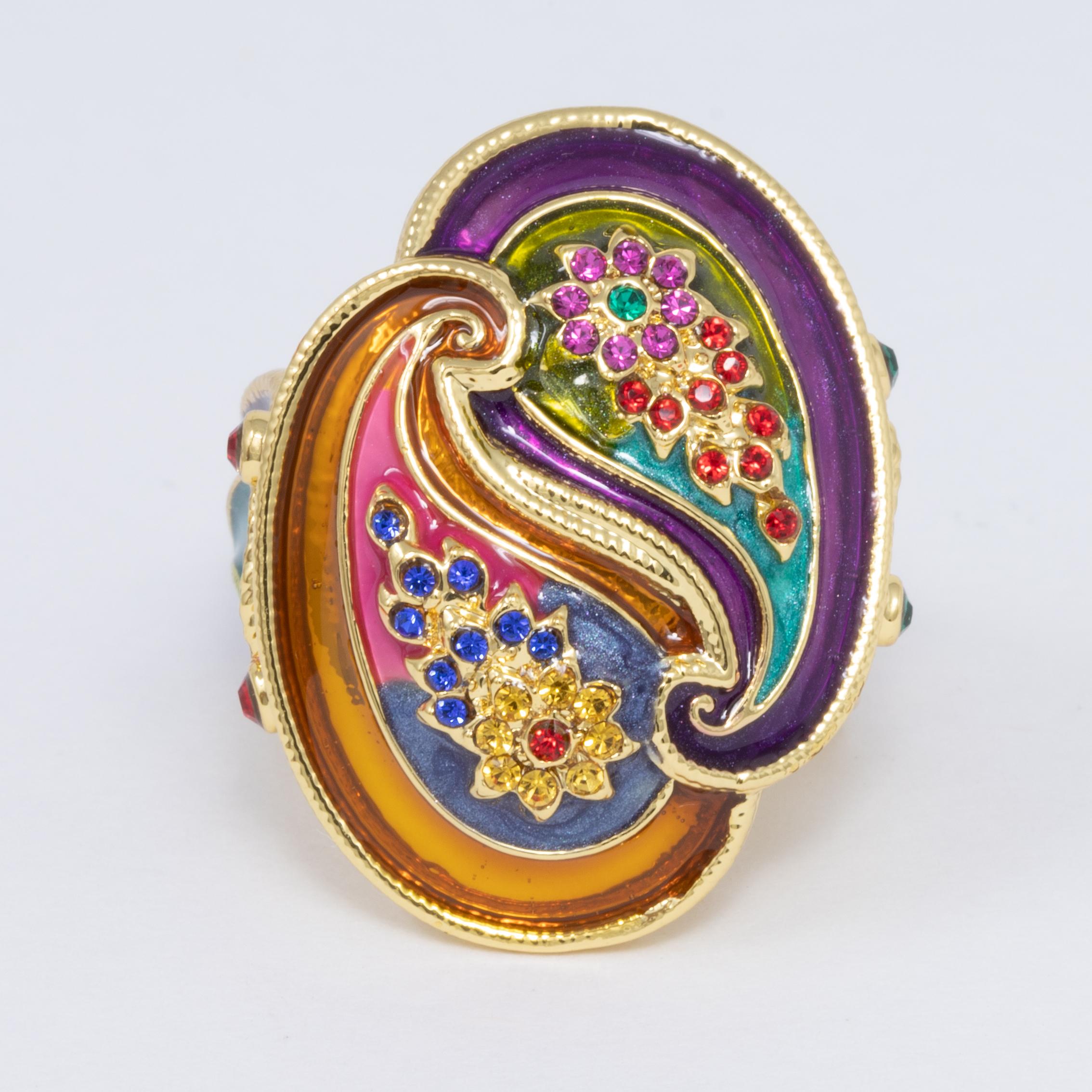 An extravagant statement ring by Jay Strongwater. This stylish accessory features a elevated twin paisley design, painted in rich purple, turquoise, and orange enamel & accented with crystals.

Ring size US 7.25

Hallmarks: Jay, Jay Strongwater,