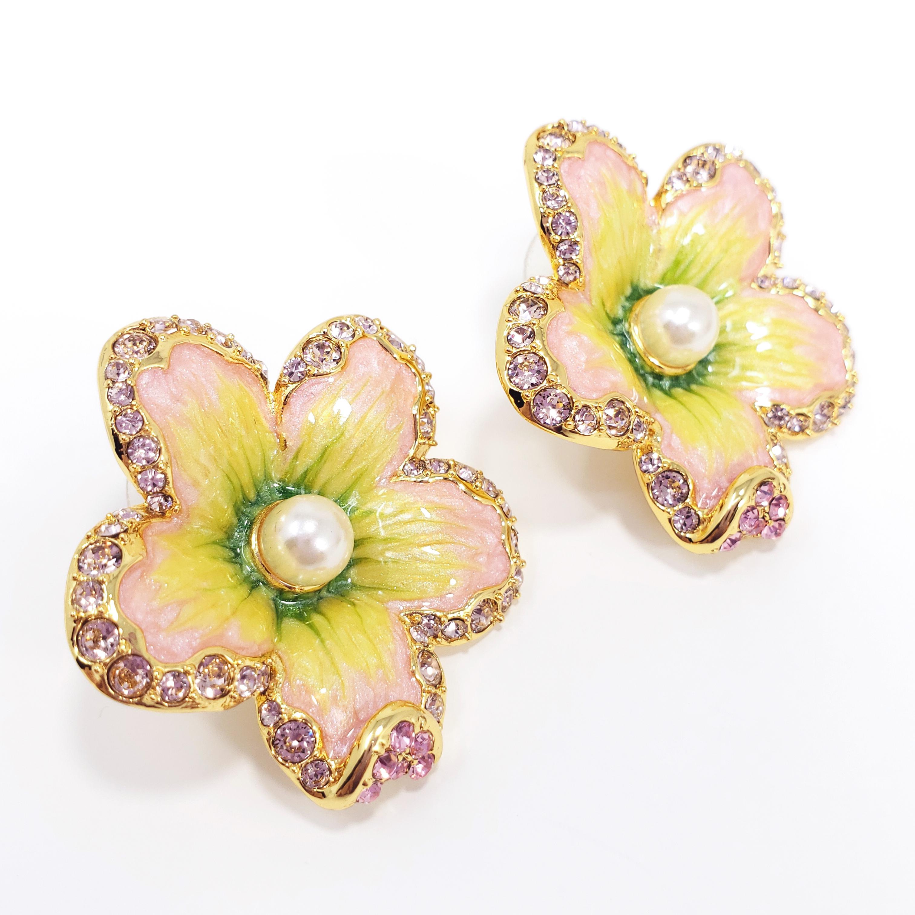 Flower power! A pair of ornate floral earrings featuring pink crystals & faux pearls. Painted with green and pink enamel, with post backs. Set on gold plated metal.

Hallmarks: Jay, Jay Strongwater, CN

By Jay Strongwater, originally for HSN.