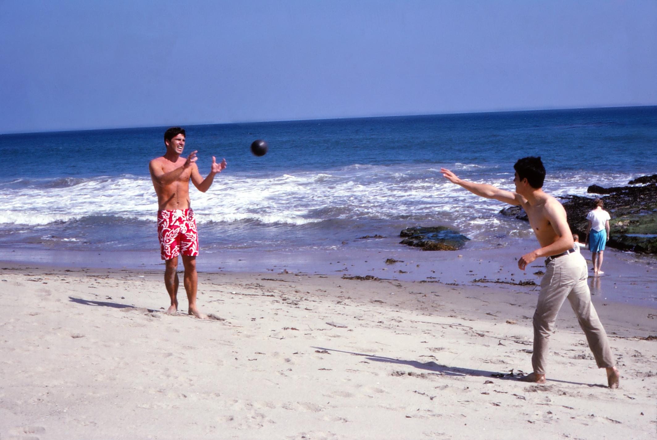 Jay Thompson Color Photograph - Bruce Lee and Van Williams Playing Ball on the Beach Fine Art Print