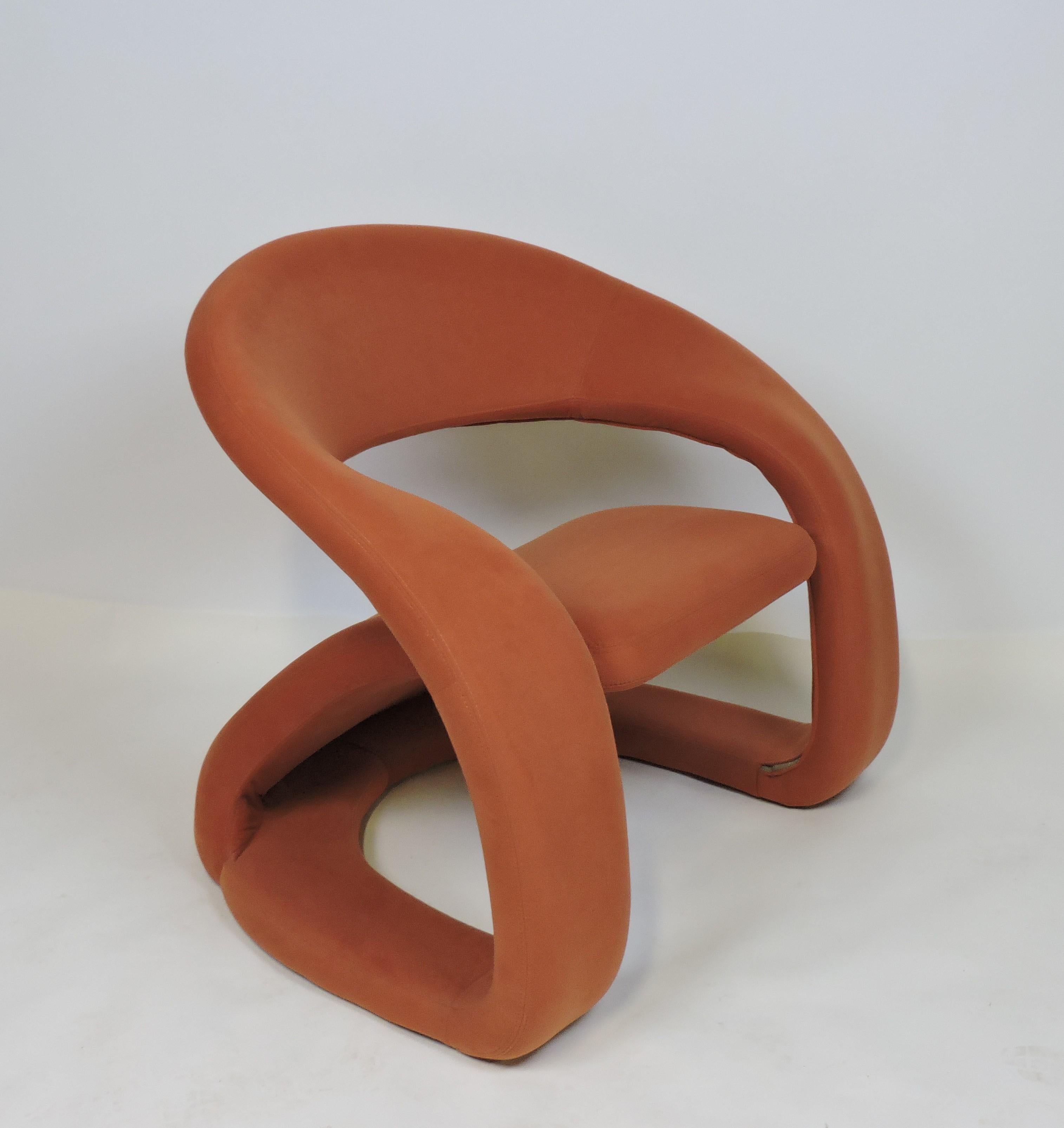 Very cool looking and comfortable lounge chair manufactured in Quebec by Jaymar. This chair has a unique and curvy sculptural design and is upholstered in the original burnt orange colored micro suede upholstery.