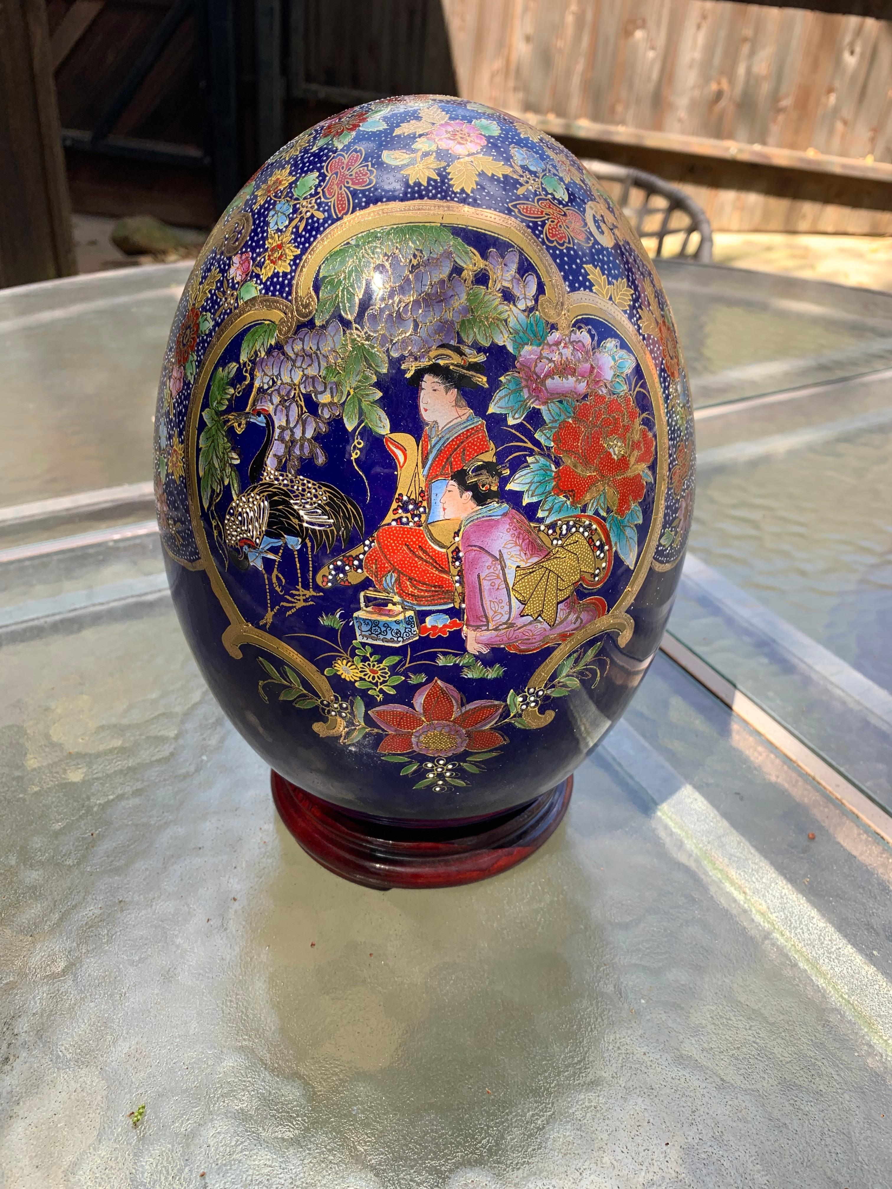  Jaymee Collection of Paris Large Porcelain Egg  Made of porcelain with cobalt blue background adorned with gold accents and detailed Geisha and floral decoration.