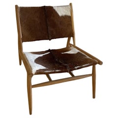 Chaise Serge de la maison Jayson avec peau de chèvre naturelle et cadre en teck