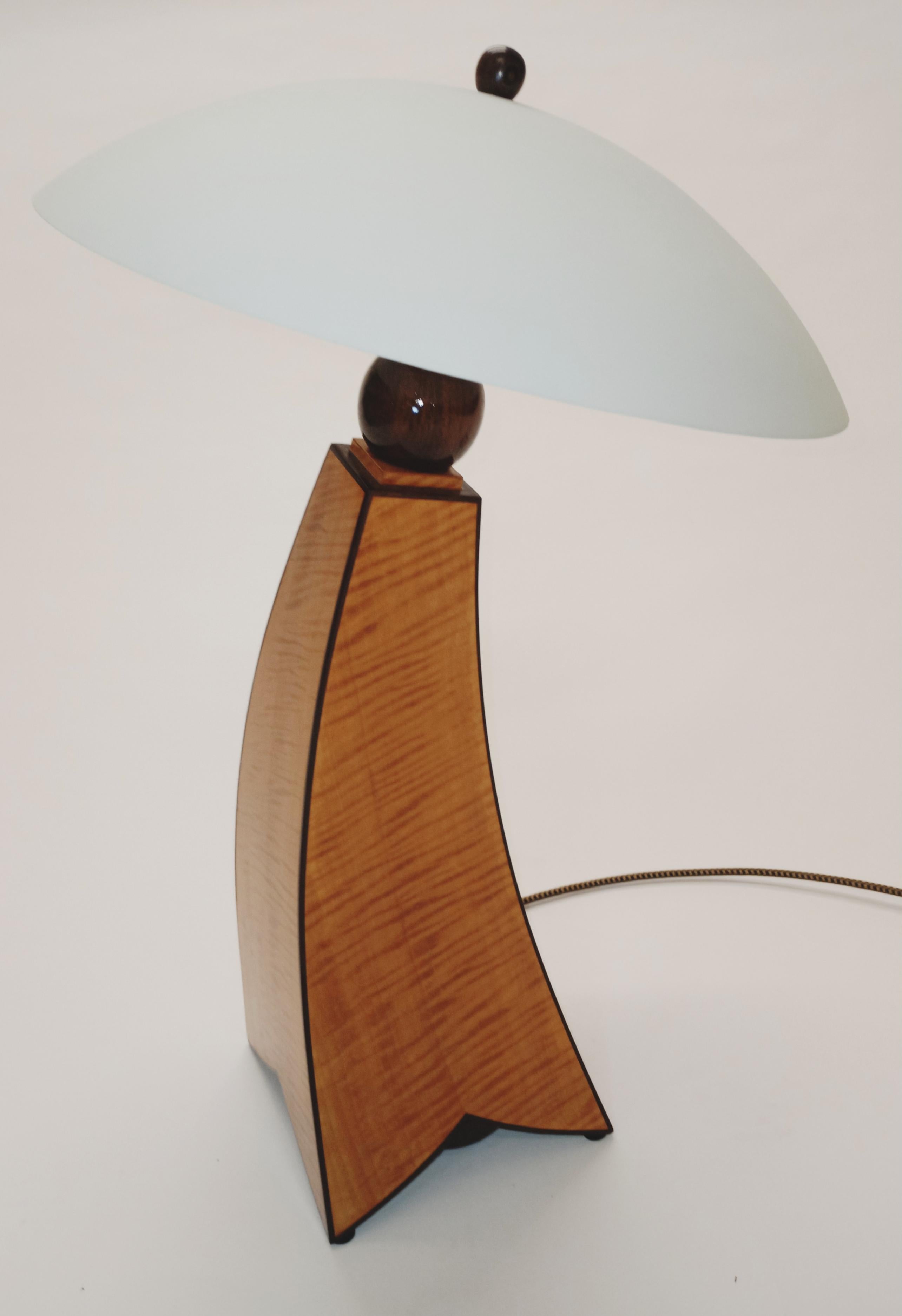 Introducing the Jazz Inspired II Fiddle Back Maple Table Lamp by Cosmo Barbaro Furniture, a masterpiece that harmoniously blends artistry and craftsmanship, inspired by the timeless allure of jazz music. Crafted with meticulous attention to detail,