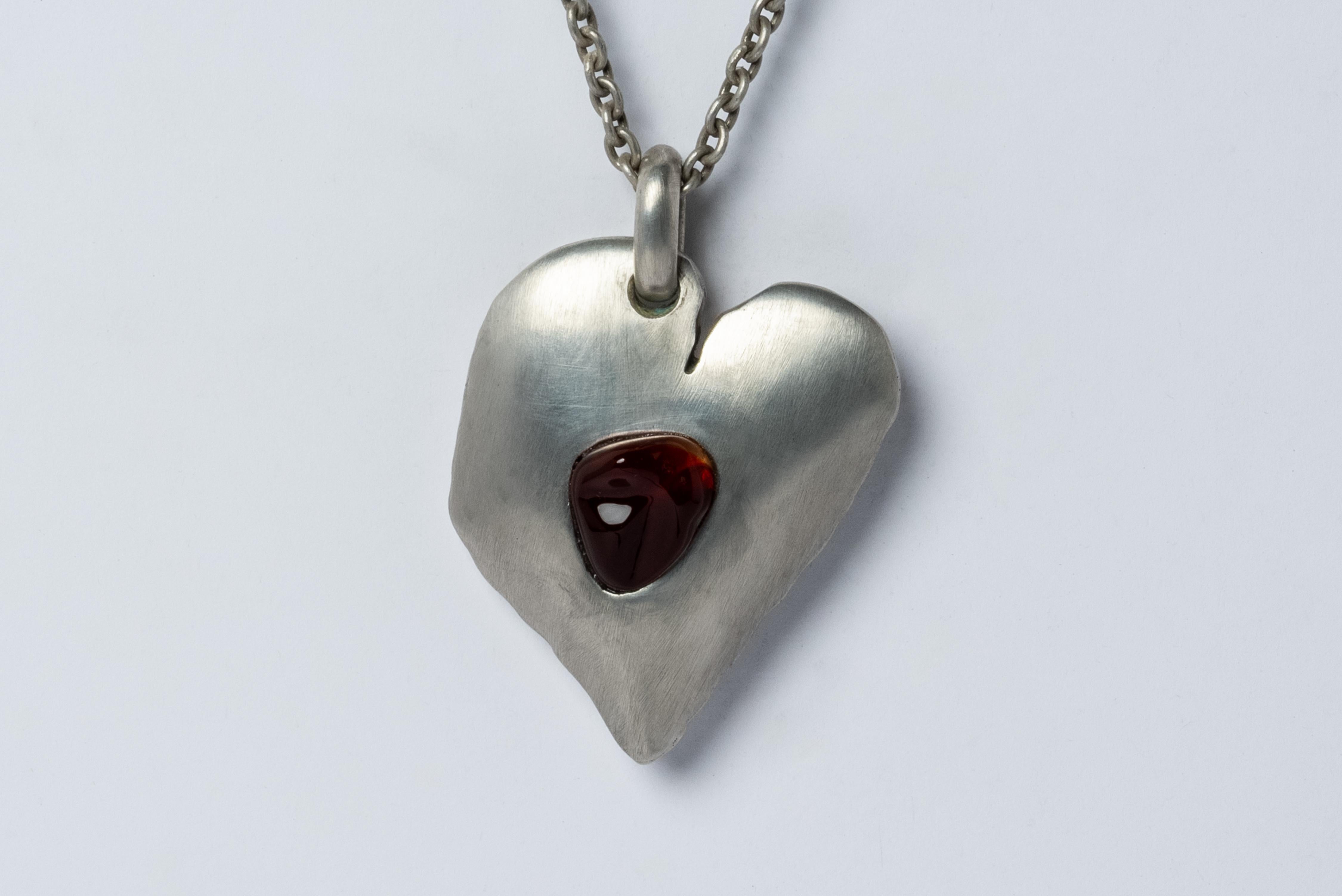 Jazz's Solid Heart Necklace made from dirty sterling silver and opal.
This series is based on a heart that Jazz, Evan’s daughter, drew directly on his chest when she was five years old. That day they went and had it tattooed directly onto Evan’s