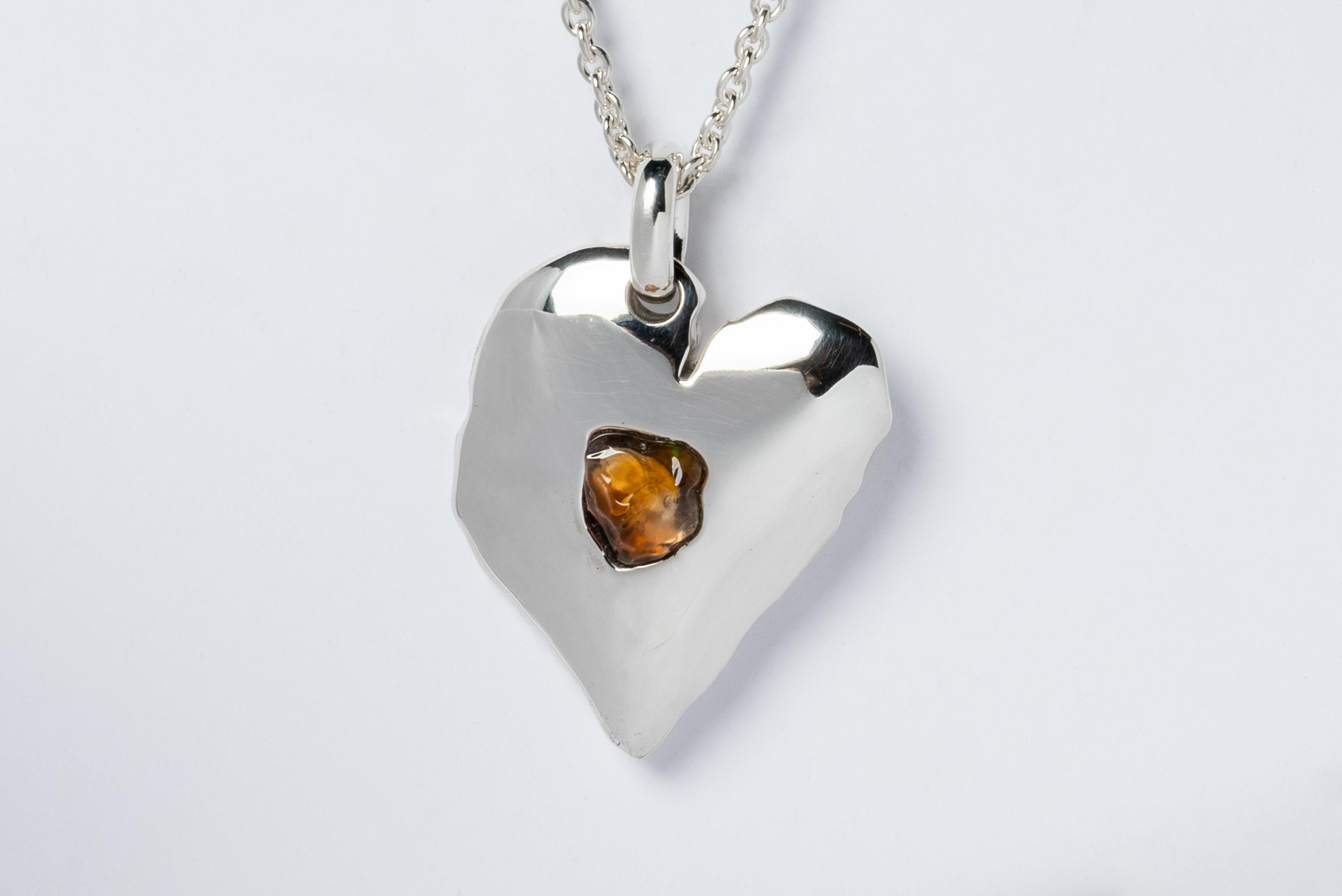 Jazz's Heart Necklace in polished sterling silver and a slab of rough opal. This series is based on a heart that Jazz, Evan’s daughter, drew directly on his chest when she was five years old. That day they went and had it tattooed directly onto