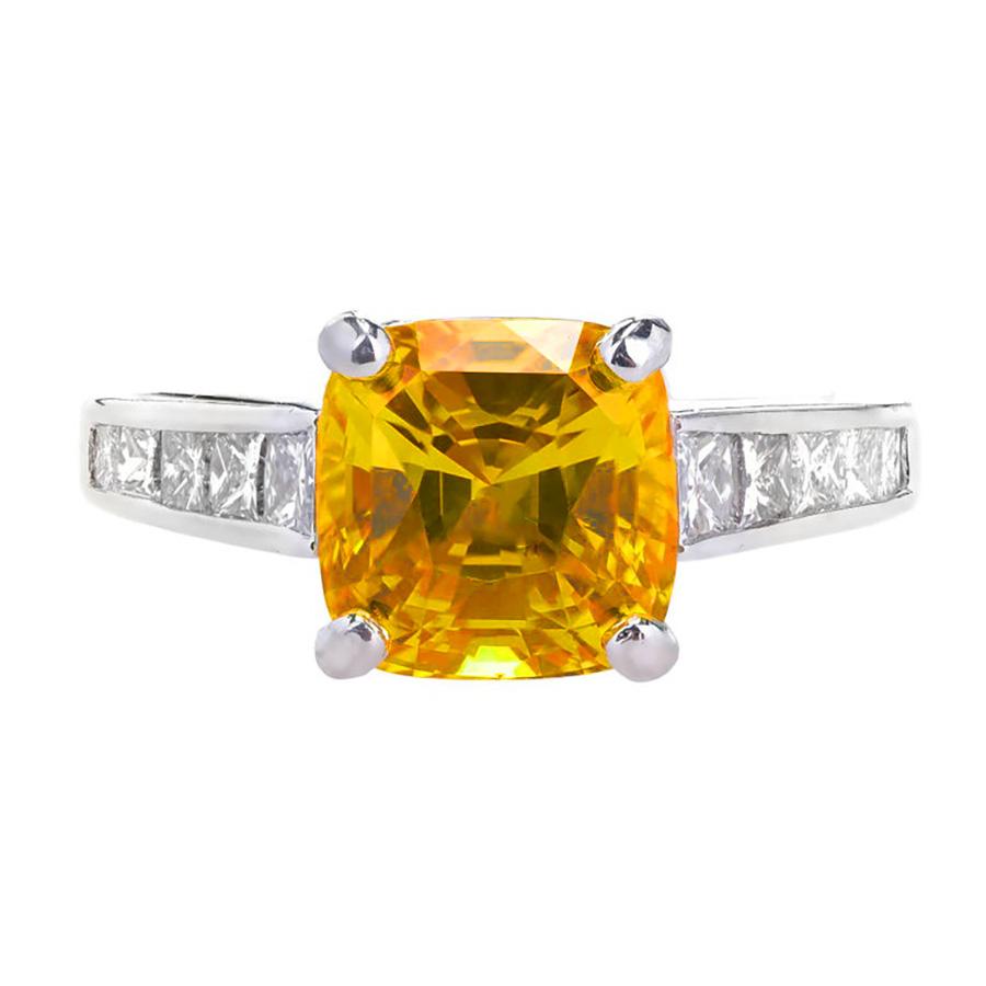 Orange cushion cut Sapphire an diamond engagement ring from JB Star. Bright yellowish orange GIA certified natural sapphire with simple heat treatment only, center stone, with 10 princess cut accent diamonds set in a platinum setting. 

Captivating
