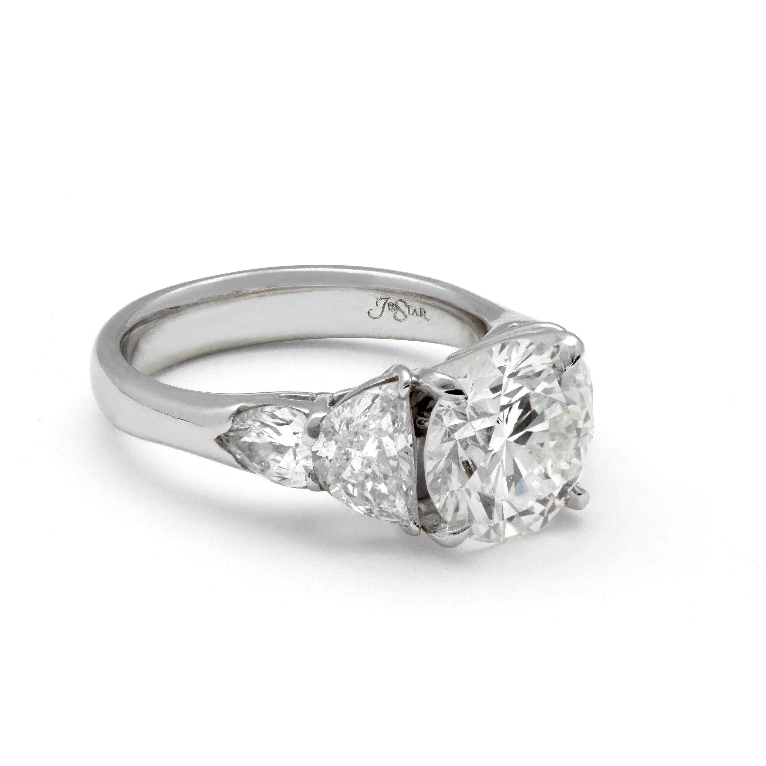 This JB Star design is cast in platinum and has a certified round brilliant cut 3.03 carat, H color and VS2 clarity diamond.  This center diamond is accompanied by .61 total carats of pear shaped diamonds and 1.00 total carats of halfmoon diamonds.