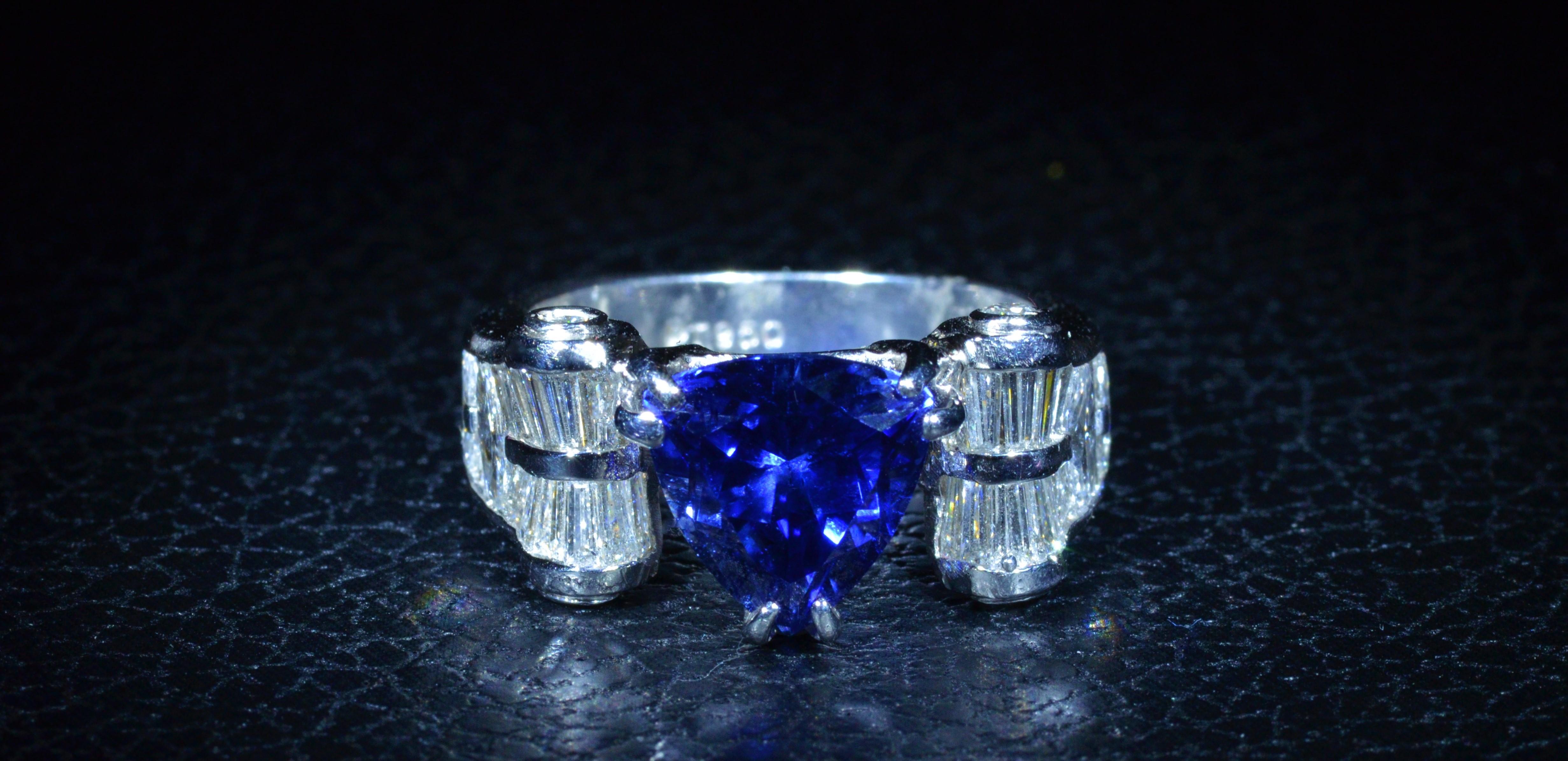 Ladies JD Star Platinum Ring set with a medium dark violetish-Blue 4.91 Carat Tanzanite.  The tanzanite is vivid in saturation.  The ring is also set with  2.50 carats of baguette cut, marquise brilliant cut, and round brilliant cut diamonds.  The