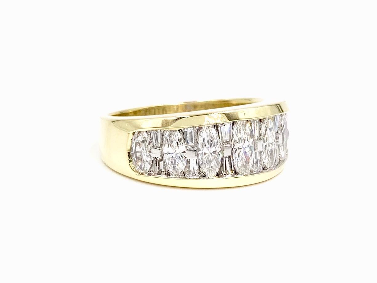 Sleek and modern 18 karat yellow gold and platinum wide diamond band by JB Star. Seven marquise and twelve baguette diamonds have a total weight of 1.41 carats, uniquely and securely set in a seamless design with platinum prongs and yellow gold