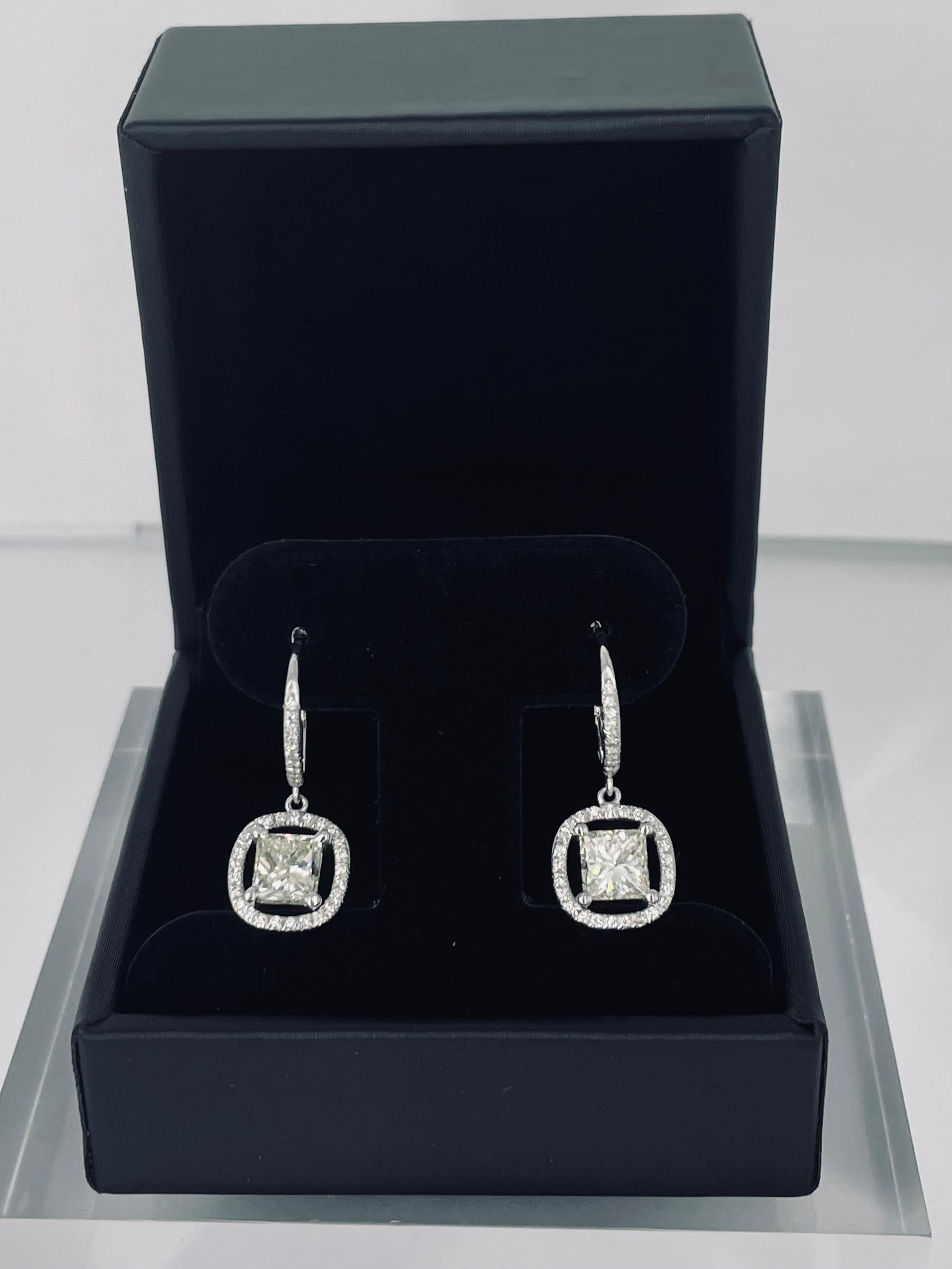 These delicate sparkling earrings by J. Birnbach are a unique take on the everyday diamond earring! A fine border of pave diamonds creates an open frame around the center princess cut diamonds. The lever back style allows for lively movement,