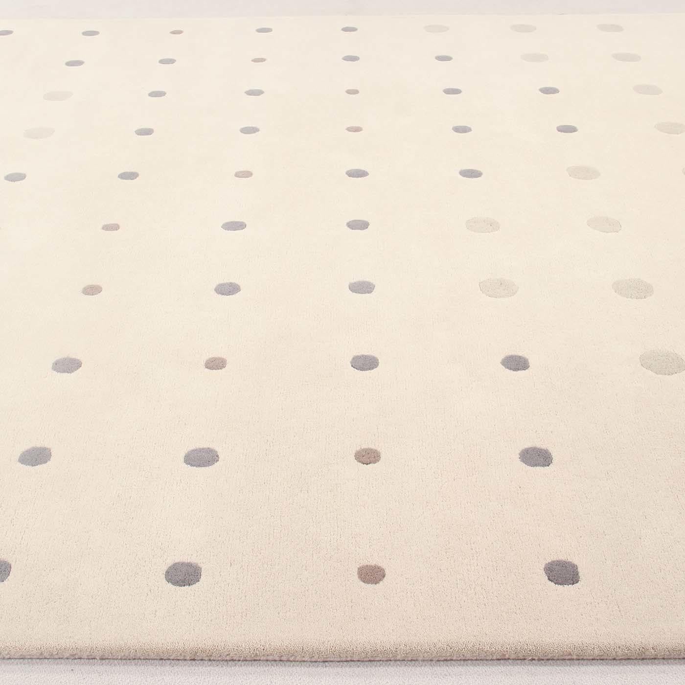 A fun and playful polka dot motif is featured on the Bubbles carpet, a design by the modern and ingenious designer Joe Colombo. Bubbles was born from the 1968 graphic design project that Joe Colombo undertook, like the Bolle table lamp in 1964. The
