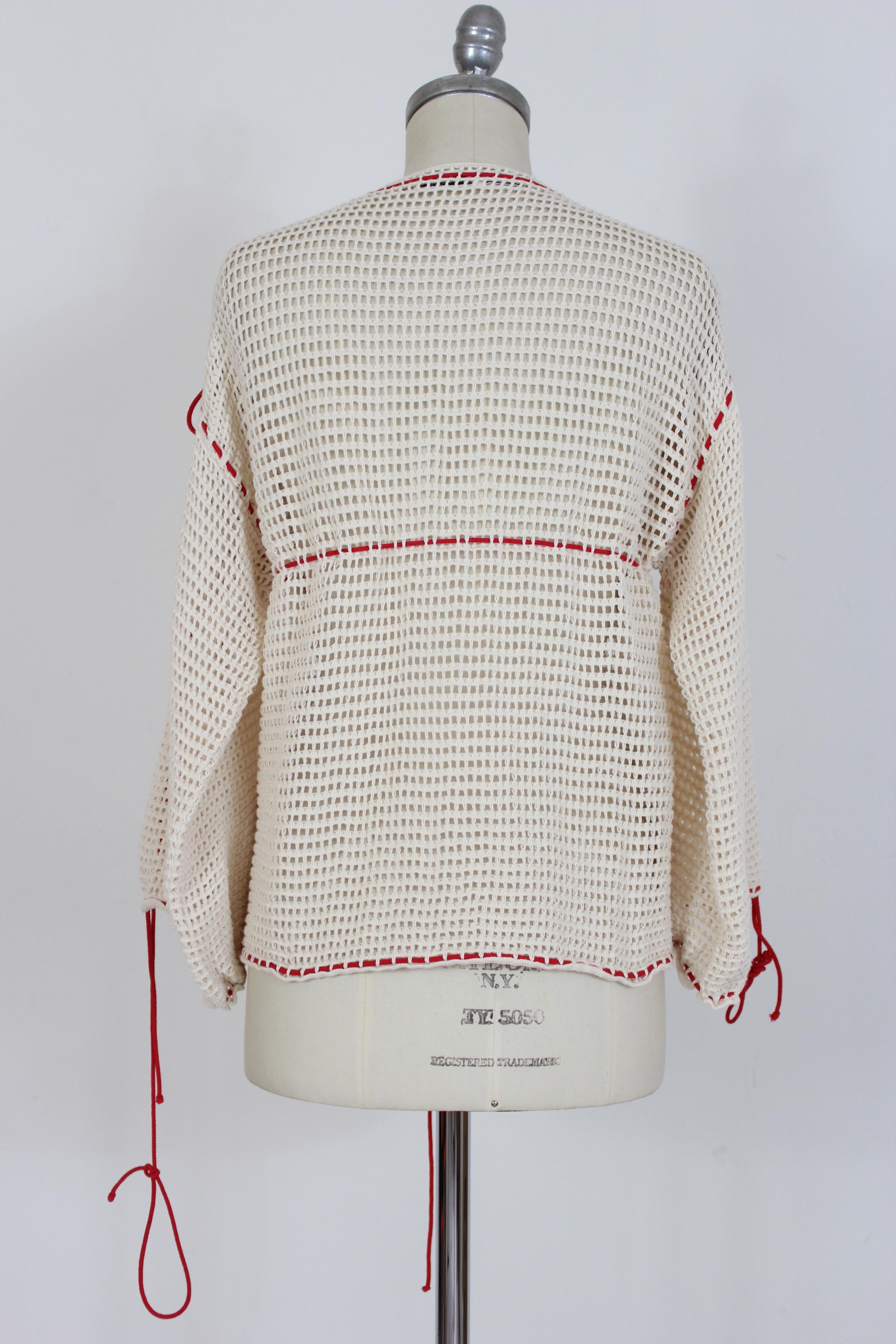 Jc de Castelbajac vintage 90s women's sweater. Short sweater, wide model. 3/4 balloon sleeve. Cotton fabric with weft and mesh. Beige color with red intertwined laces. Made in France.

Condition: Excellent

Item used few times, it remains in its