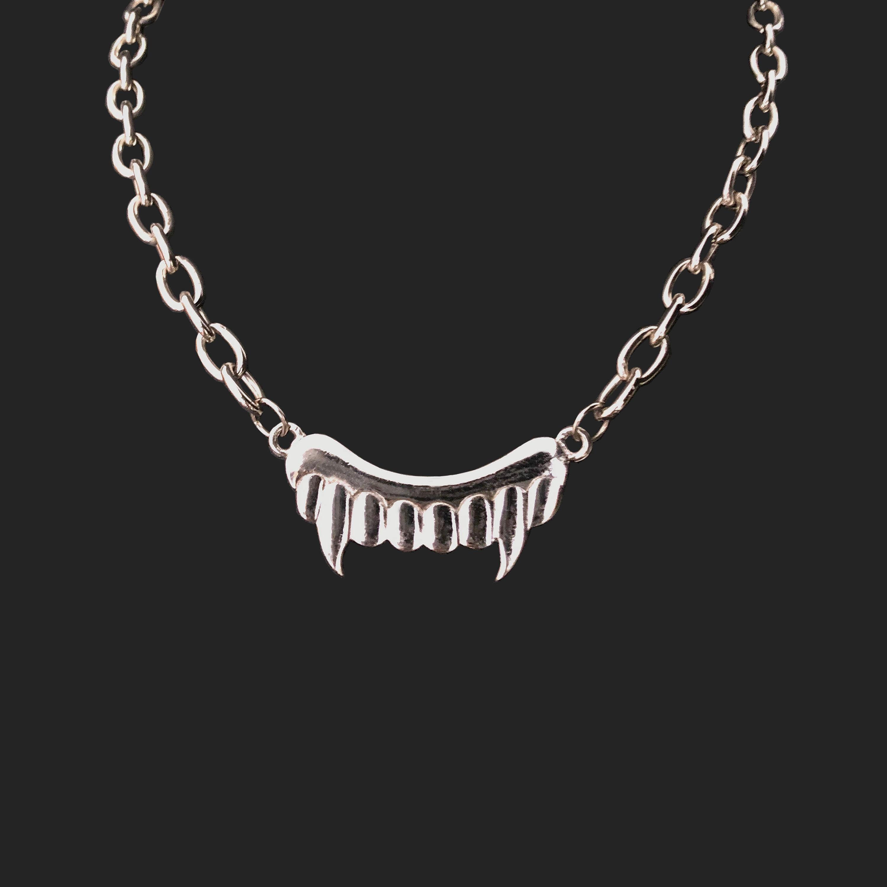 Product Details: JC de Castelbajac - Silver ‘Fang’ Necklace - 1990s Vintage - Chunky Chain - ‘JC de Castelbajac Logo’ / Back Pendant - Secure Twist / Back Fasten 
Era: c.1990
Label: JC de Castelbajac
Fabric Content: Silver Metal
Necklace Total