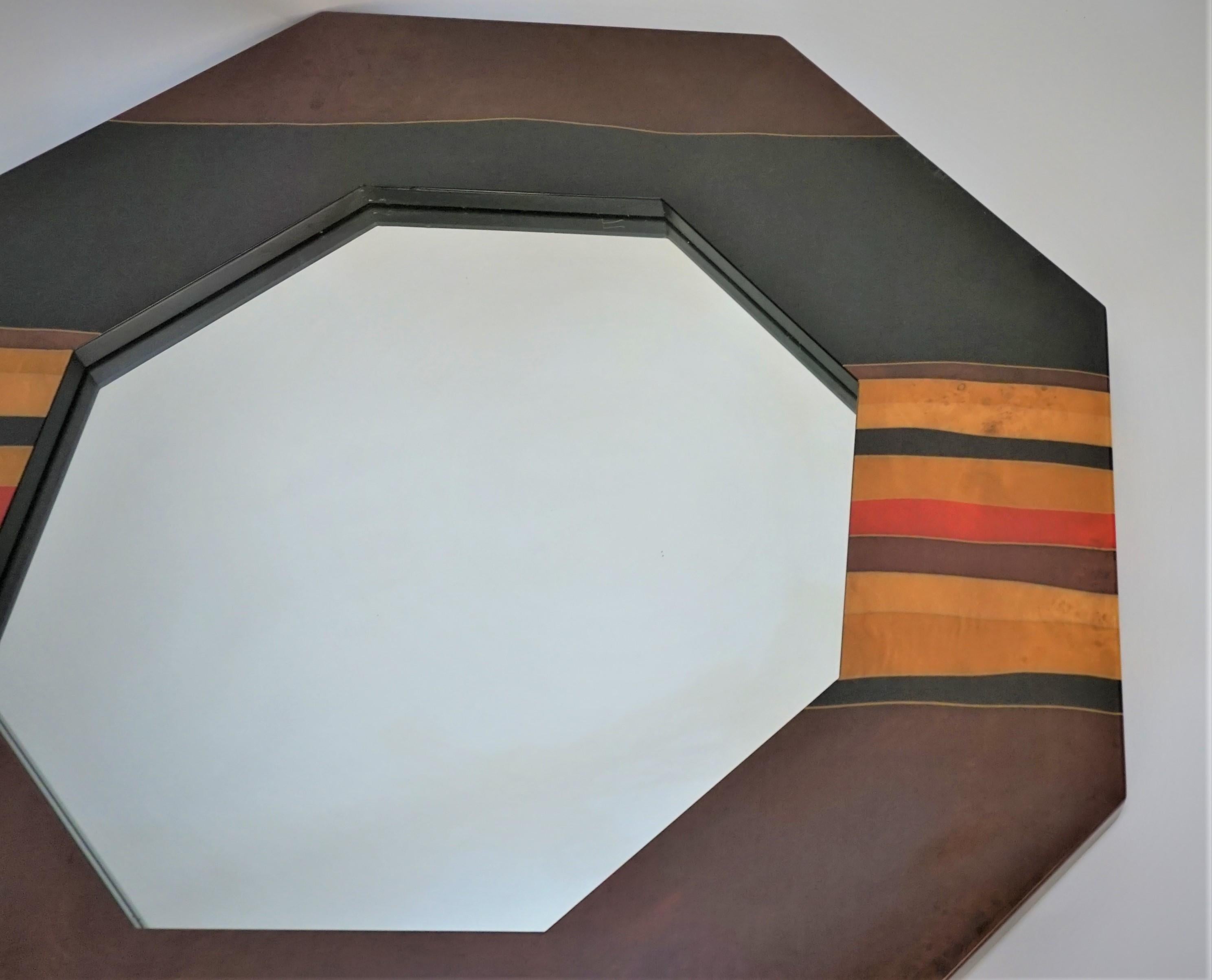beautiful 1970's octagon shaped French wall mirror in multi color lacquered wood by J.C. Mahey.