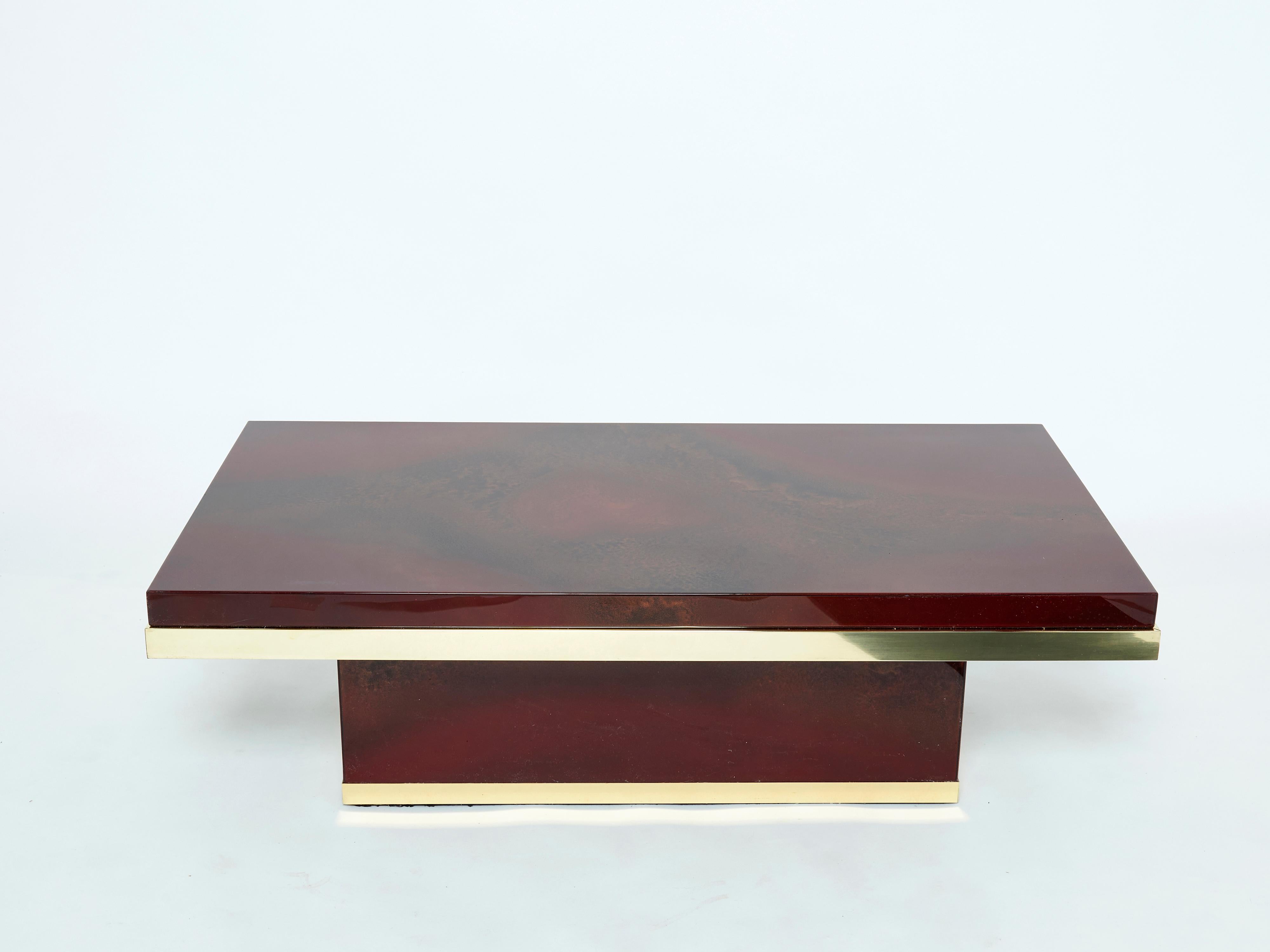 This stunning coffee table is guaranteed to be the focus of attention when you entertain guests in your living room. Following the glamorous mid-century look of other classic Jean Claude Mahey designs, the gleaming bronze and cherry red lacquered