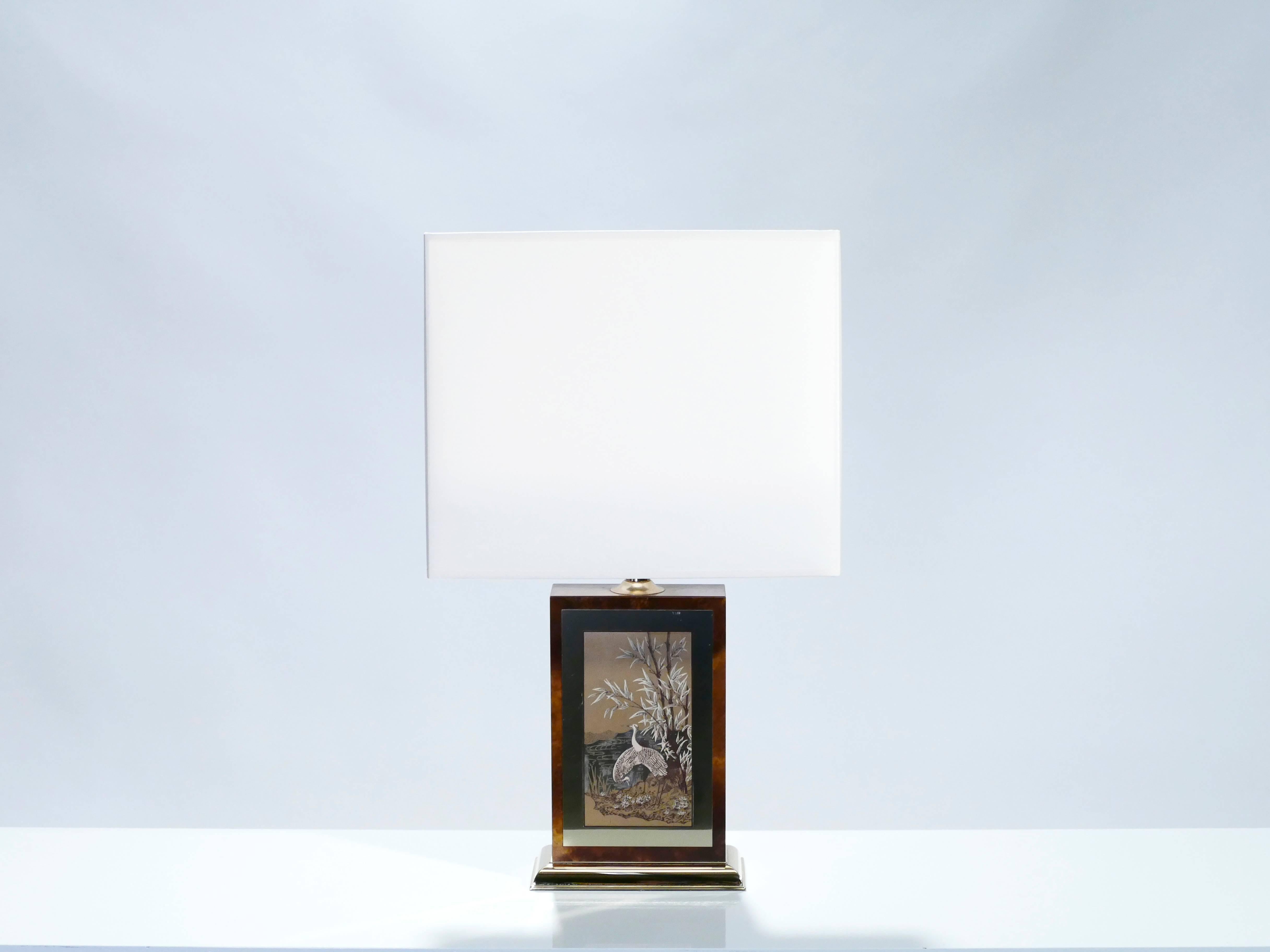 This lamp is typical of designer Jean Claude Mahey’s midcentury brass and lacquer work. A rich burl wood base feels serious and sophisticated, and is offset by a brass frame with a beautiful lacquer French natural decor. The lamp is found in very