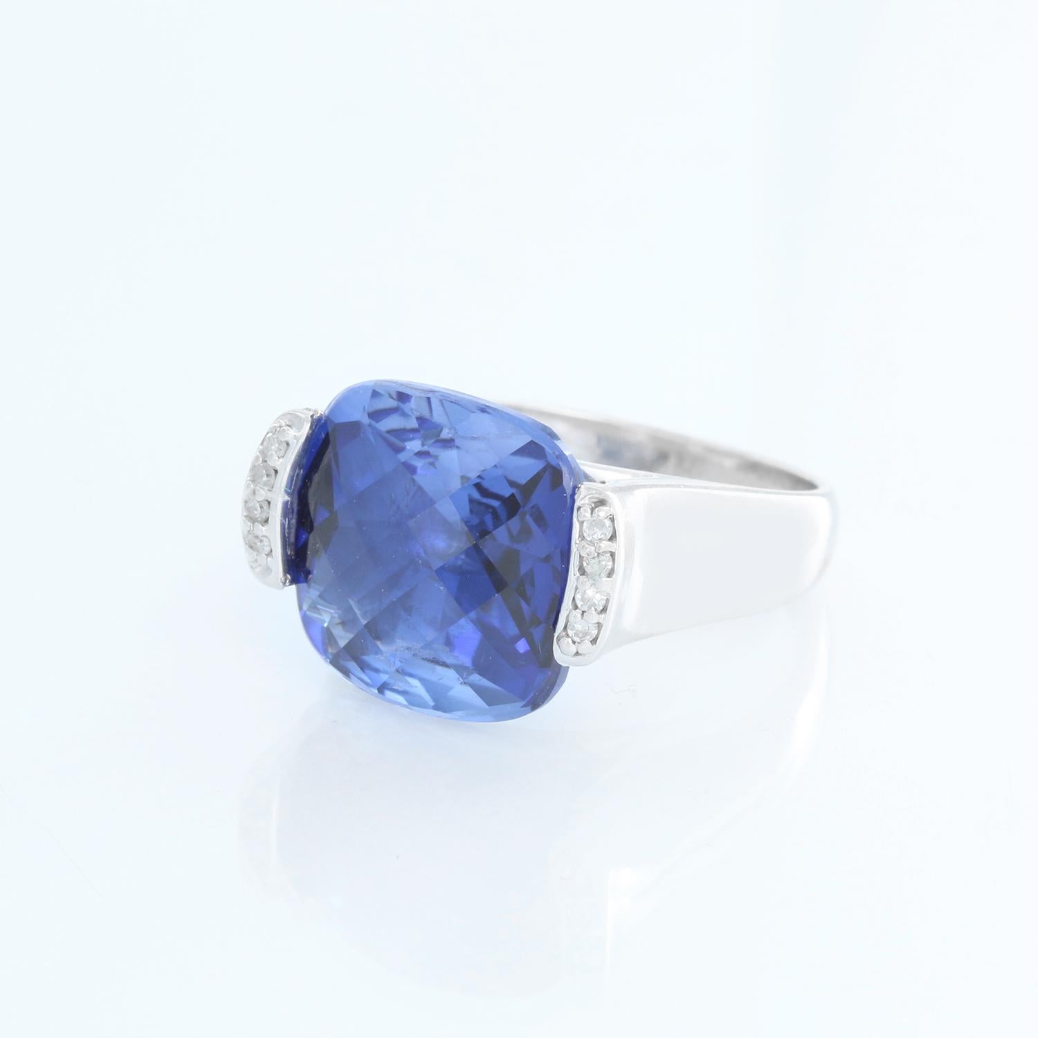 John C. Rinker designer ring. Set in 14K White gold with a cushion cut Sapphire weighing 6 cts. with .6 cts of diamond around the stone. Total weight 9.6 grams. Can be sized