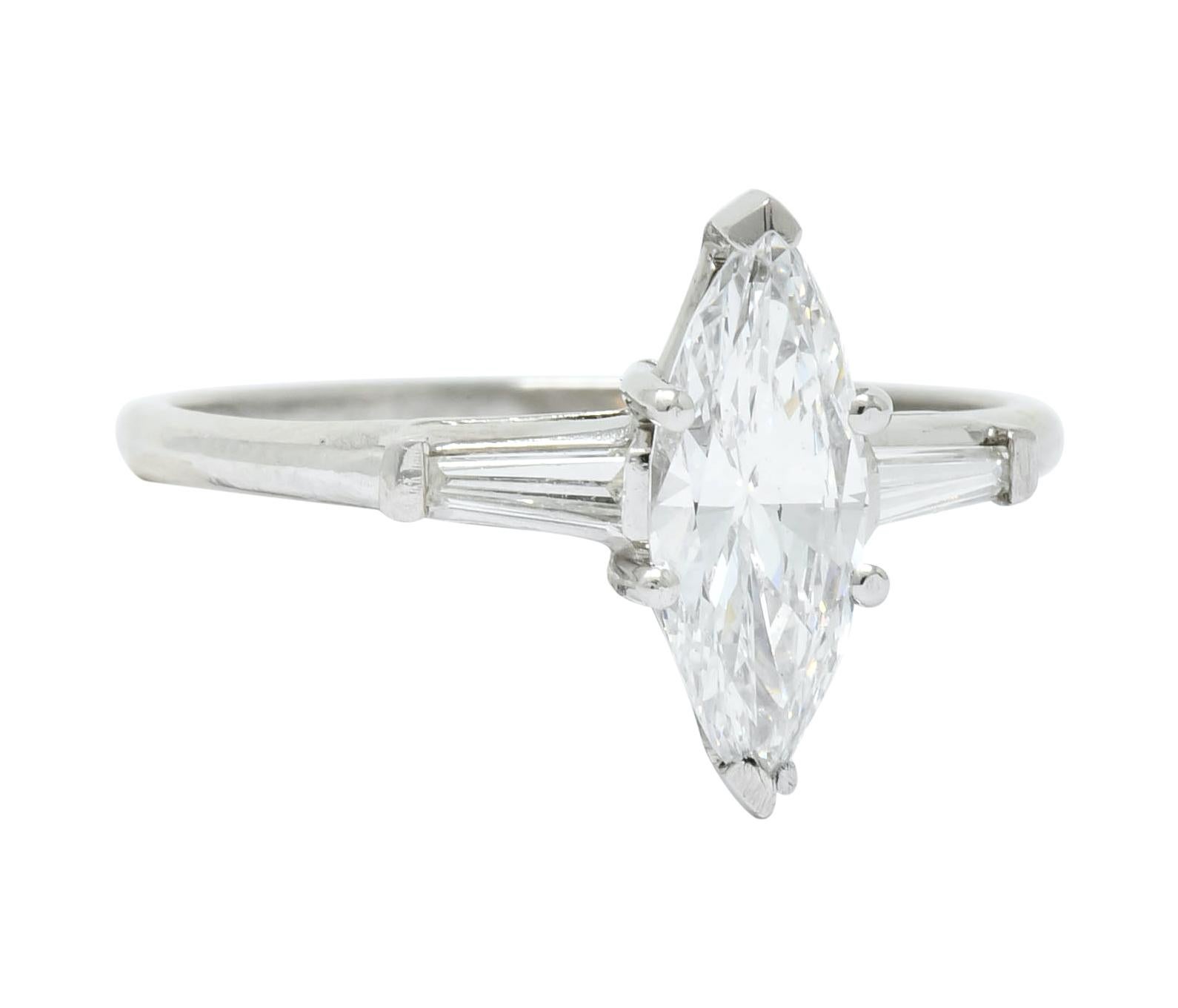 Centering a marquise cut diamond weighing 0.87 carat, E color and VS2 clarity, basket set with V tip prongs

Flanked by bar set tapered baguettes weighing approximately 0.16 carat total, E/F color and VS clarity

With maker's mark for J.E. Caldwell