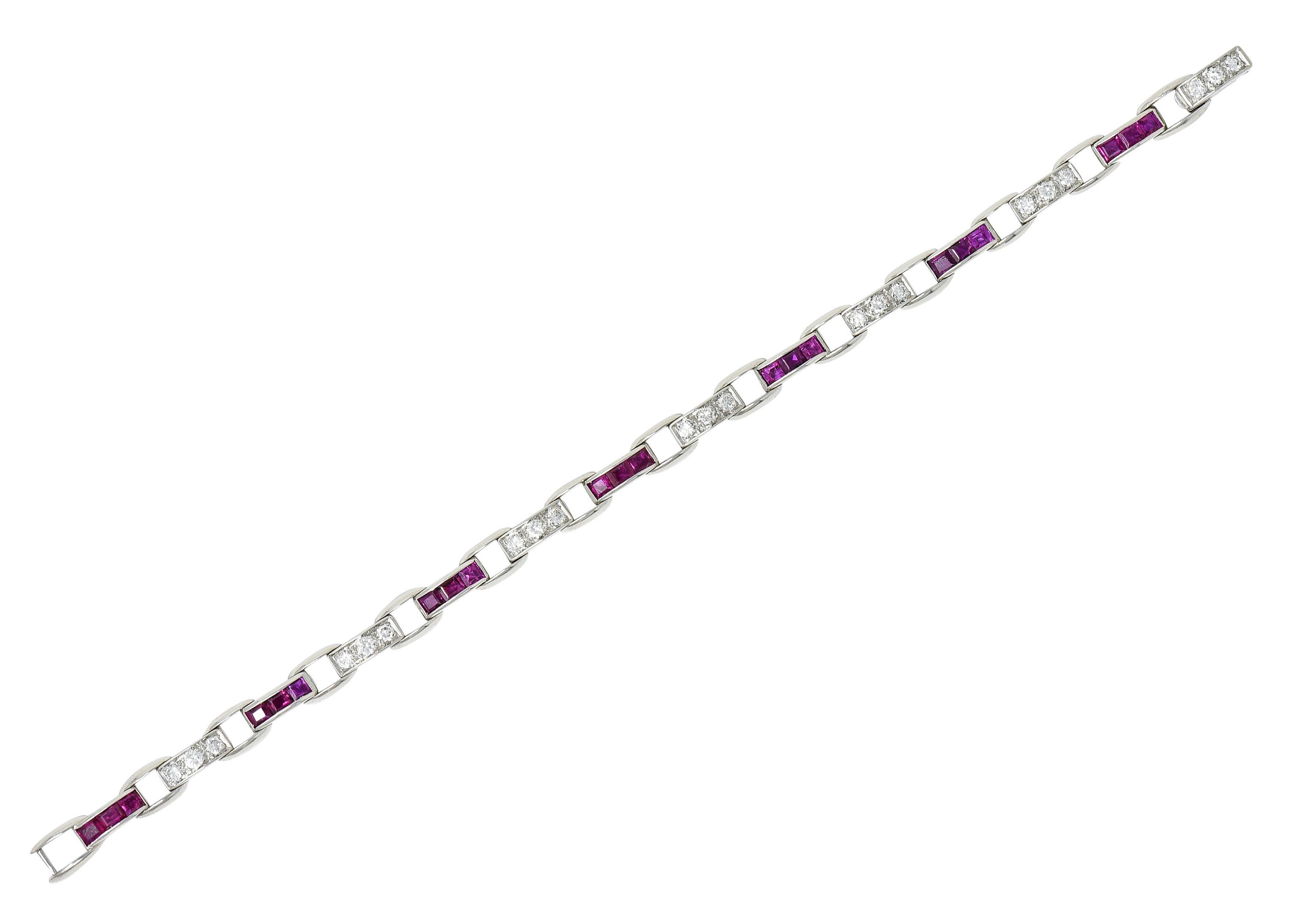 Bracelet is comprised of stylized buckle links

With rows of channel set rubies alternating with bead set round brilliant cut diamonds

Rubies are strongly purplish red while weighing in total approximately 3.00 carats

While diamonds weigh in total