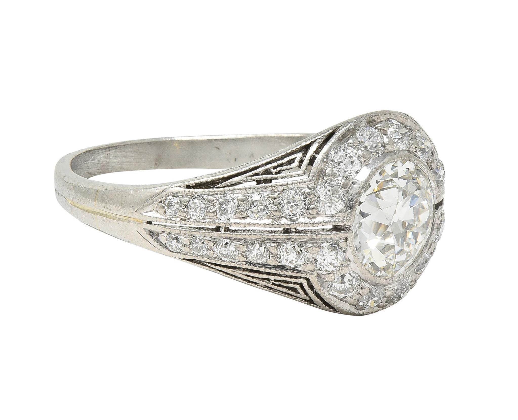 Centering an old European cut diamond weighing approximately 0.74 carat - J color with VS clarity
Set by split bezel with a bombé shaped surround bead set with old single cut diamonds
Forming a split halo and extending down shoulders in symmetrical