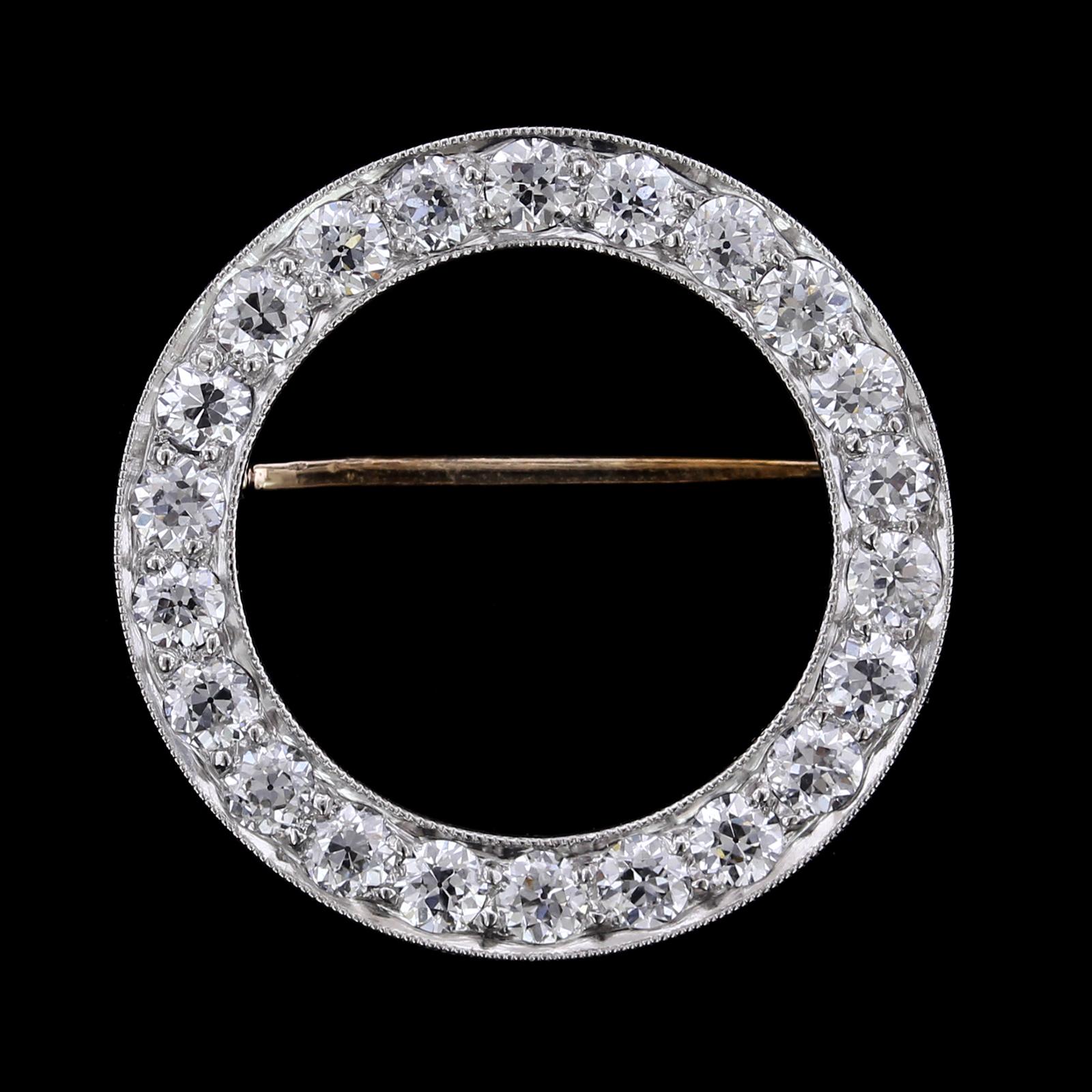 J.E. Caldwell Art Deco Platinum and Diamond Circle Pin. The pin is bead set with
22 old European cut diamonds, approx. total wt. 1.50cts., G-H color, VS clarity, #G8943,
diameter 1
