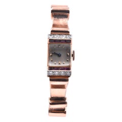 J.E. Reloj Caldwell & Co. de oro rosa de 14 quilates, rubí y diamantes