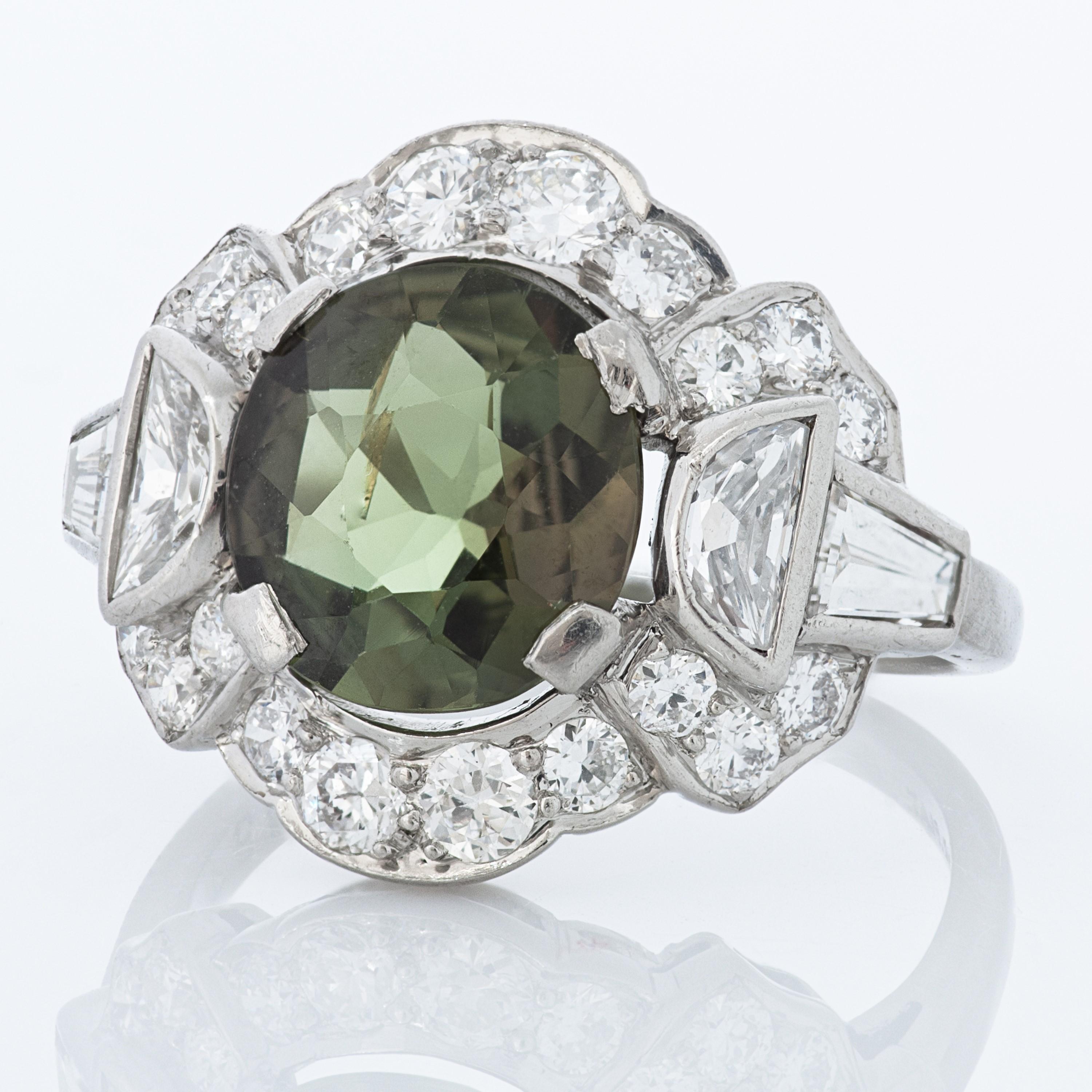 J.E. Caldwell & Co. Art Deco alexandrite and diamond platinum ring.

This J.E. Caldwell ring features a cushion cut alexandrite weighing 1.87 carats, accompanied by an AGL brief report.  The Alexandrite is surrounded by 2 half moon shaped diamonds