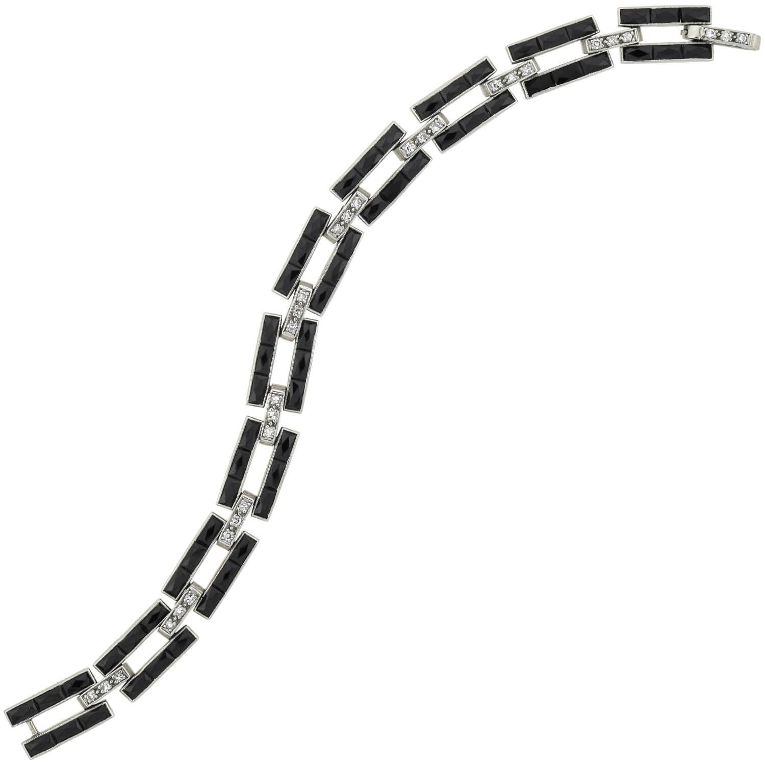 A simply fabulous Art Deco (ca1920s) era onyx and diamond bracelet from legendary American maker J.E. Caldwell & Company. This bold piece is crafted in platinum and features ten open links which come together to form a straight but flexible design.