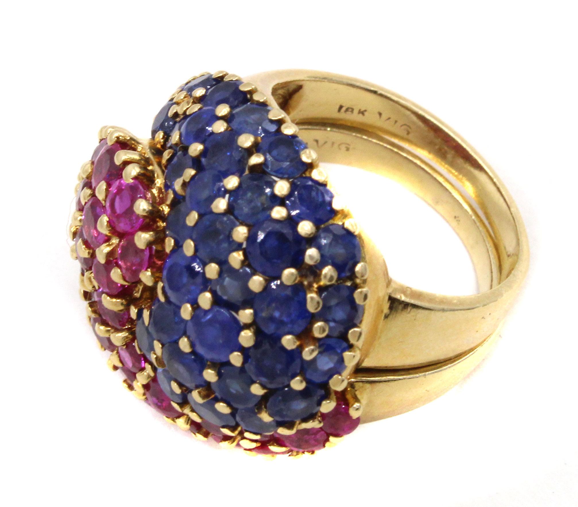 Unique 18 karat yellow gold retro ruby sapphire puzzle ring by J.E. Caldwell & Co. Amazingly designed and masterfully handcrafted this ring from ca 1945 depicts the alpha-omega symbol , half set with vibrant pinkish red rubies and the other half
