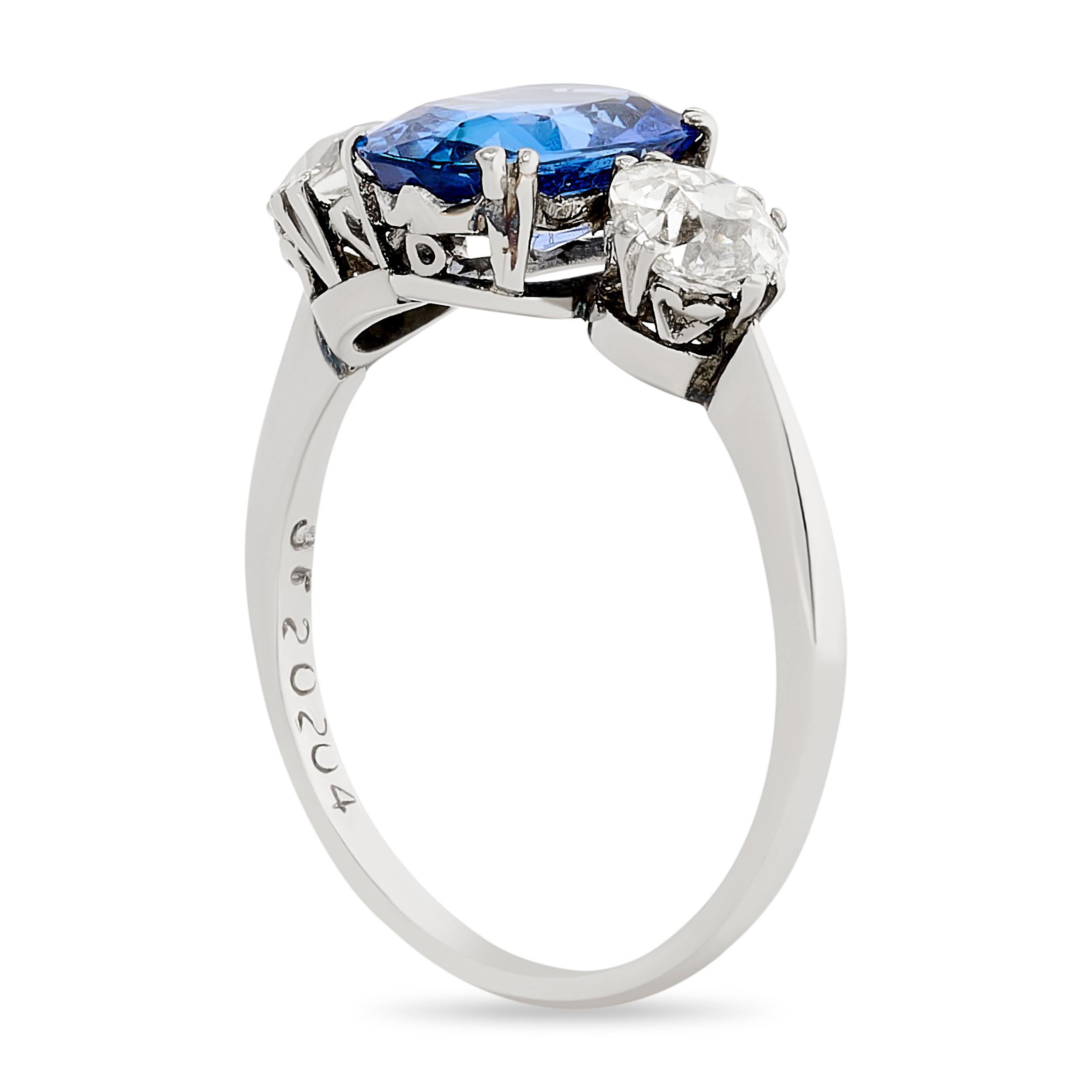 A J.E. Caldwell sapphire and old european cut diamond three-stone ring—a captivating union of a deep blue sapphire and sparkling old diamonds, weaving a story of enduring elegance and classic charm.

The center of this ring is a 2.17 carat unheated