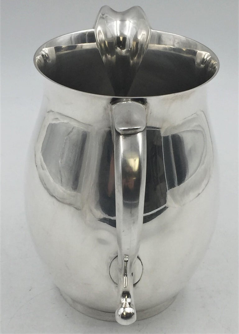 J. E. Caldwell & Co. sterling silver bar pitcher, measuring 7.7 inches in height and 8.3 inches from handle to spout, and weighing 22.5 troy ounces, and bearings hallmarks as shown.

Until the early 1850s Caldwell had its own production of