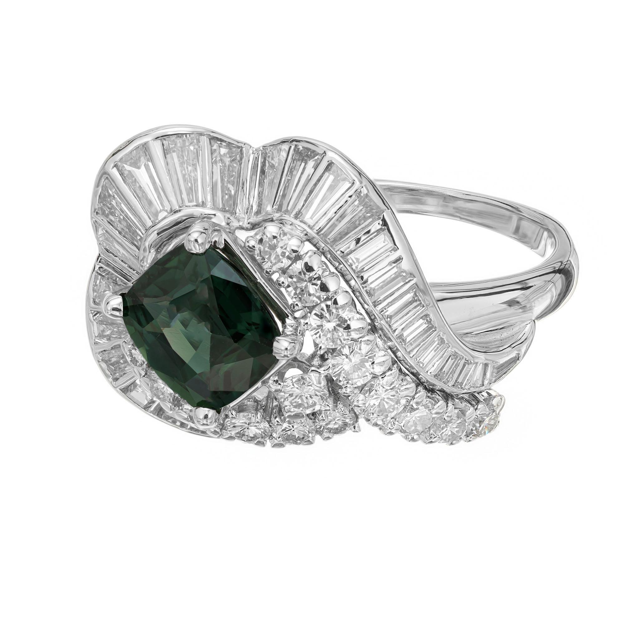 JE Caldwell 1950's dinner cluster cocktail ring. GIA certified center cushion cut green natural no heat sapphire in a platinum setting with 17 round brilliant and 28 baguette cut diamonds. 

1 cushion cut green-blue sapphire, VS approx. 1.63cts GIA